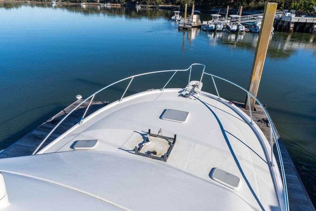 2004 Luhrs 36 Convertible yacht docked at a serene marina.