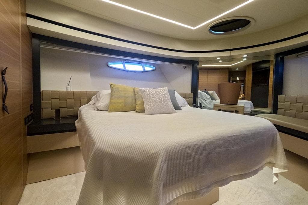 Luxurious bedroom interior of 2012 Pershing 92 yacht with modern design and elegant furnishings.