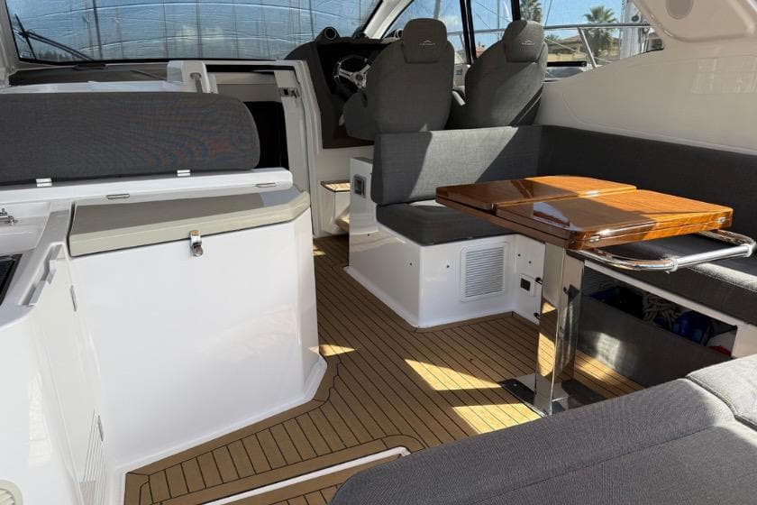 2023 Azimut Atlantis 45 yacht interior with sleek seating and wooden table.