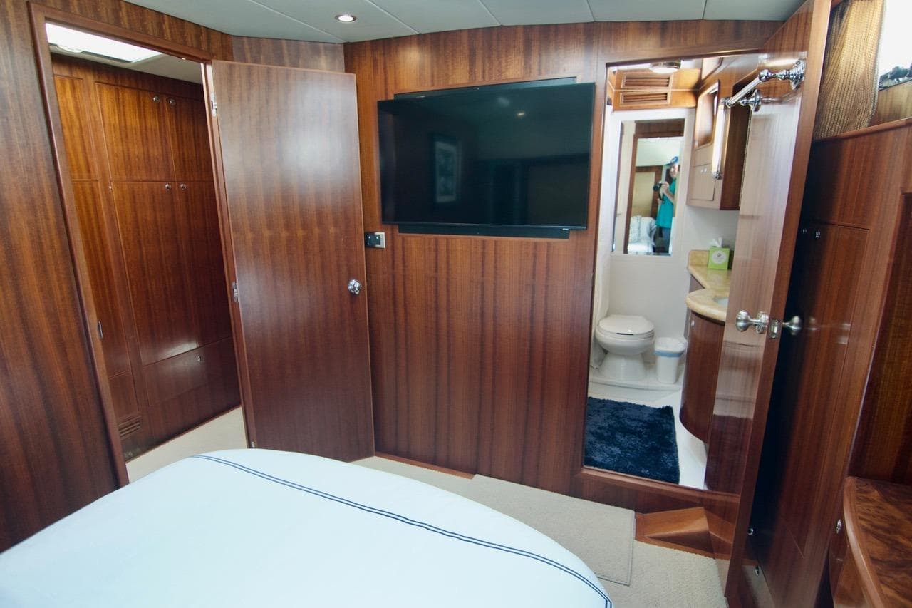 Luxurious 2007 Norseman 560 Sedan yacht interior with wood paneling and ensuite bathroom.