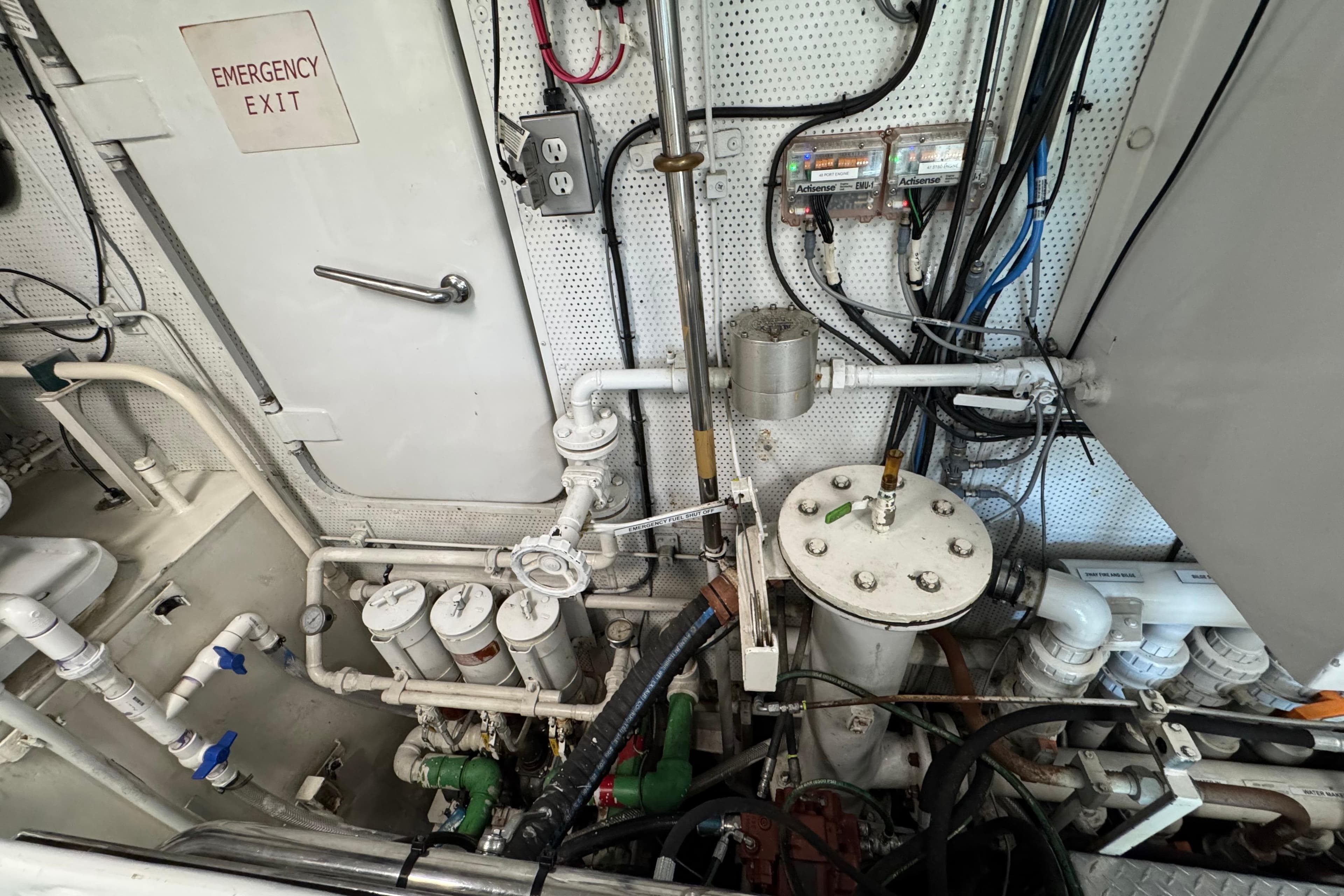 Engine room of a 2001 Doogersbank Vipack with emergency exit and complex piping system.