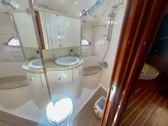 Luxurious bathroom in 2011 Regal 46 Sport Coupe yacht with dual sinks and shower.