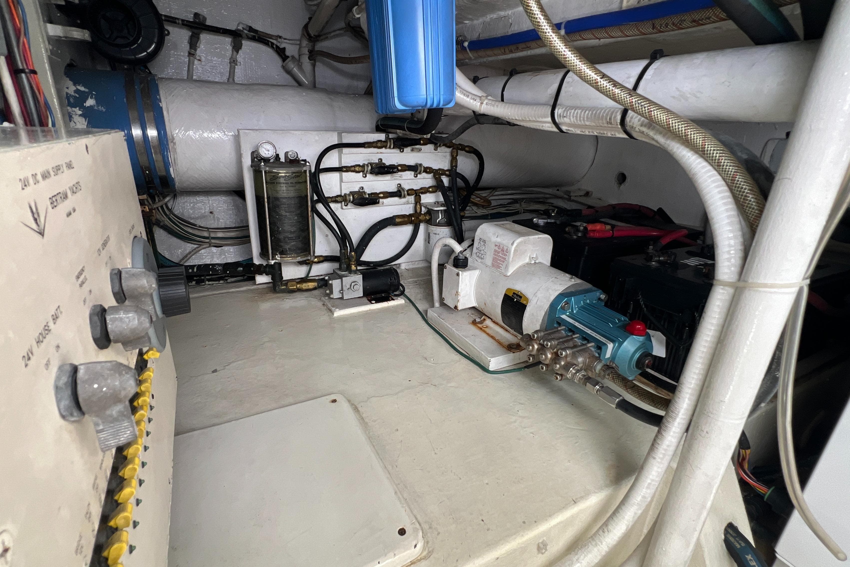 Engine room of a 2005 Bertram 450 yacht, showcasing mechanical components and wiring.