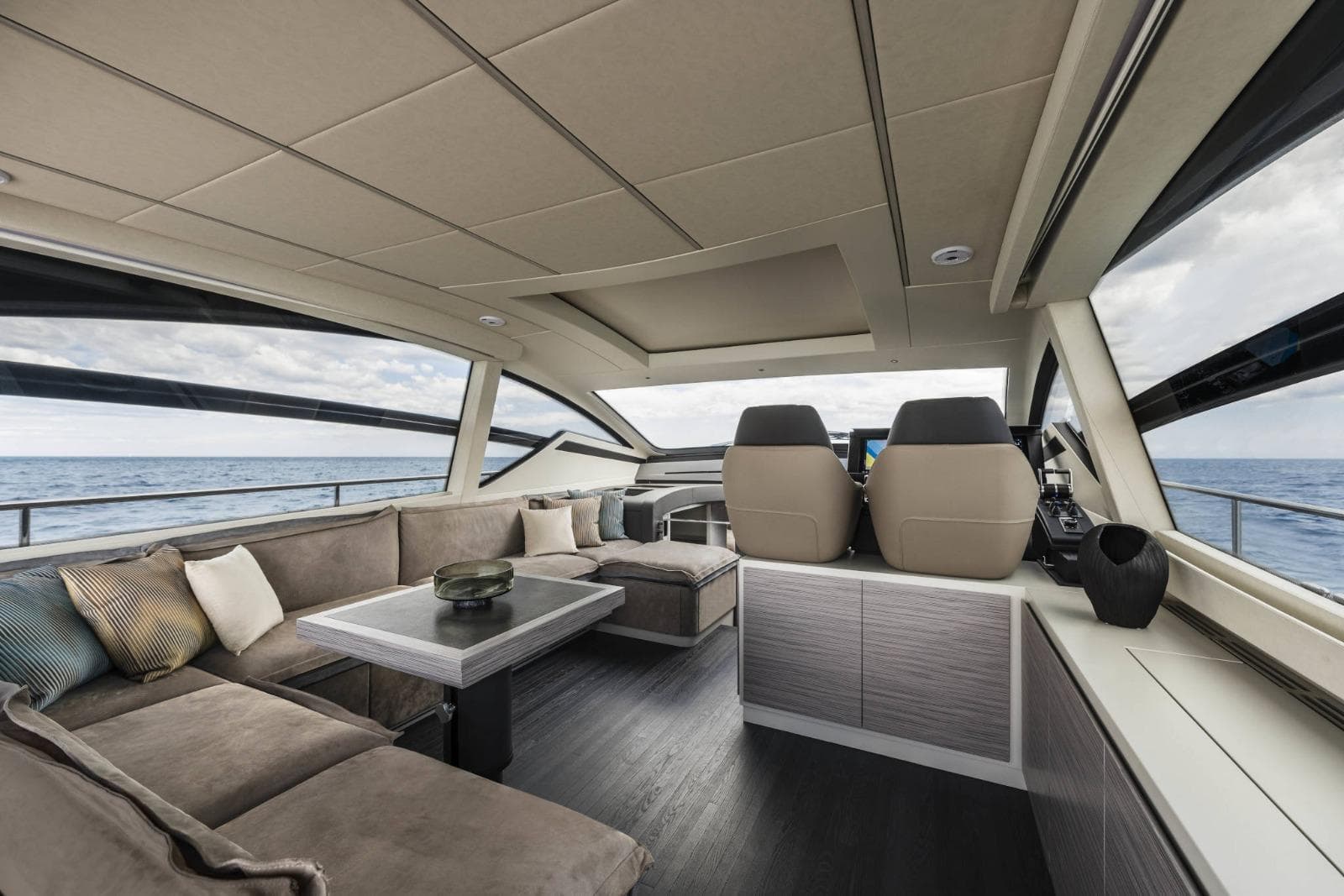 Luxurious interior of 2023 Pershing 6X yacht with modern seating and ocean view.