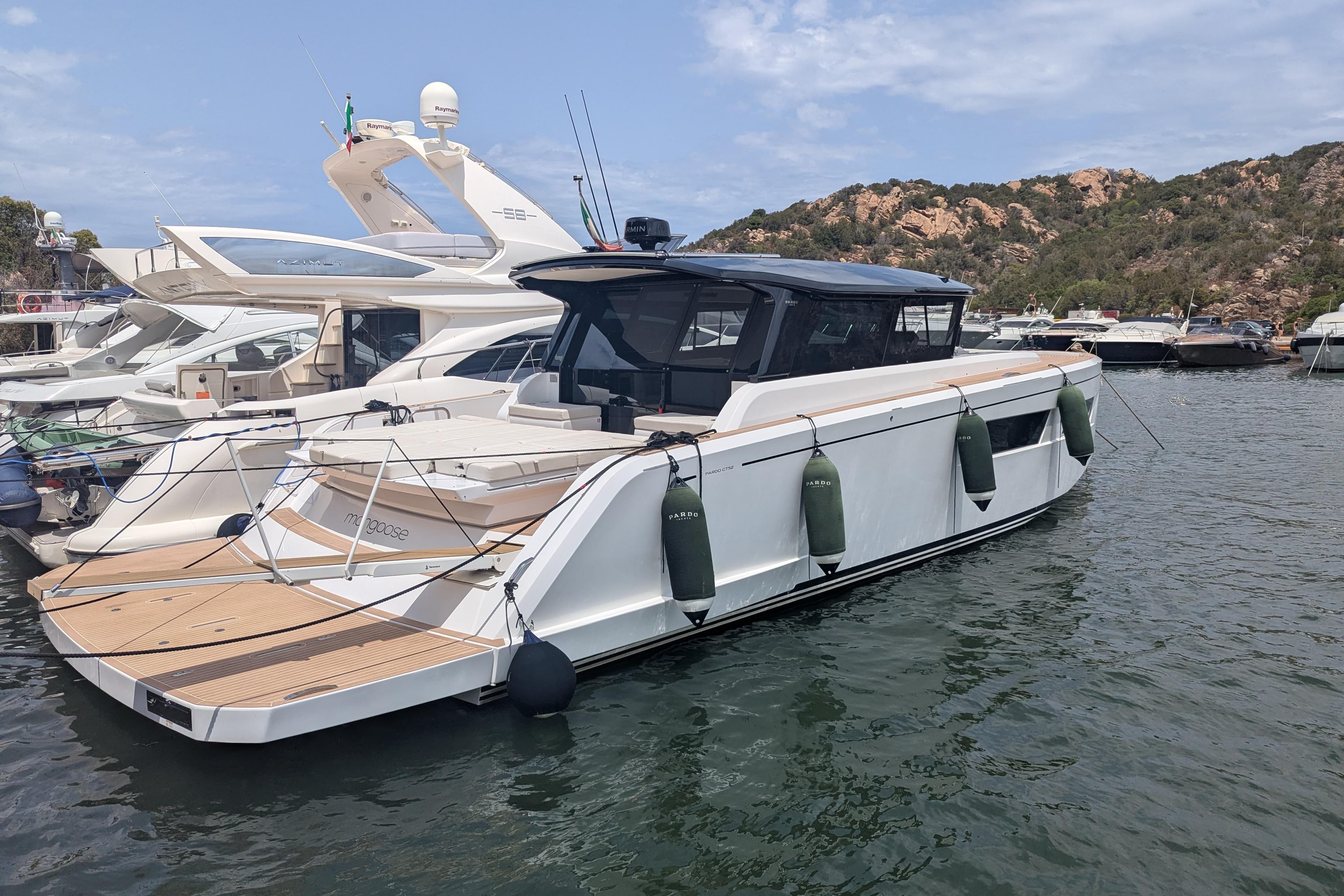 2024 Pardo Yachts GT52 docked in a scenic marina setting.
