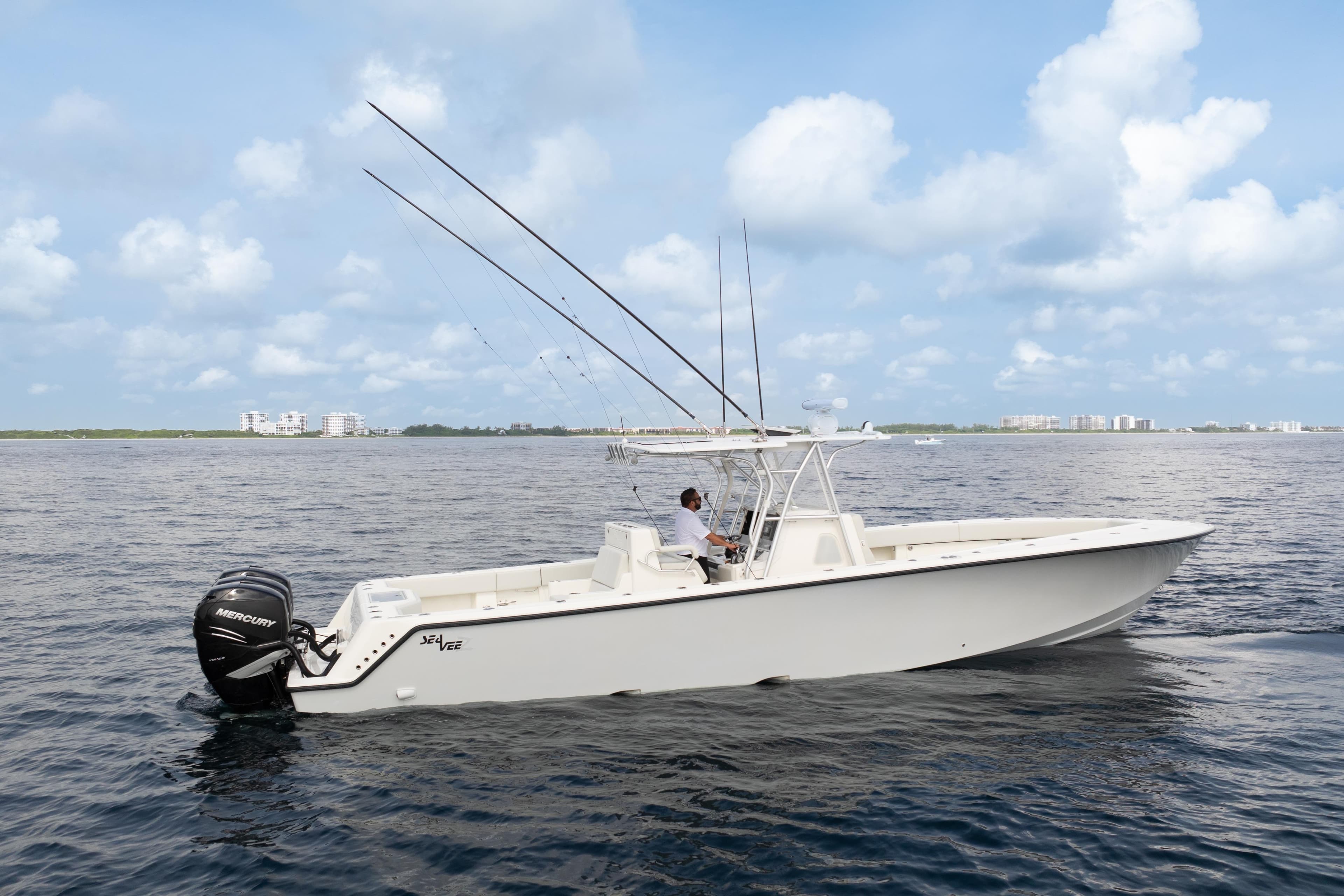 2015 SeaVee 39Z boat on open water, featuring fishing rods and Mercury engines.