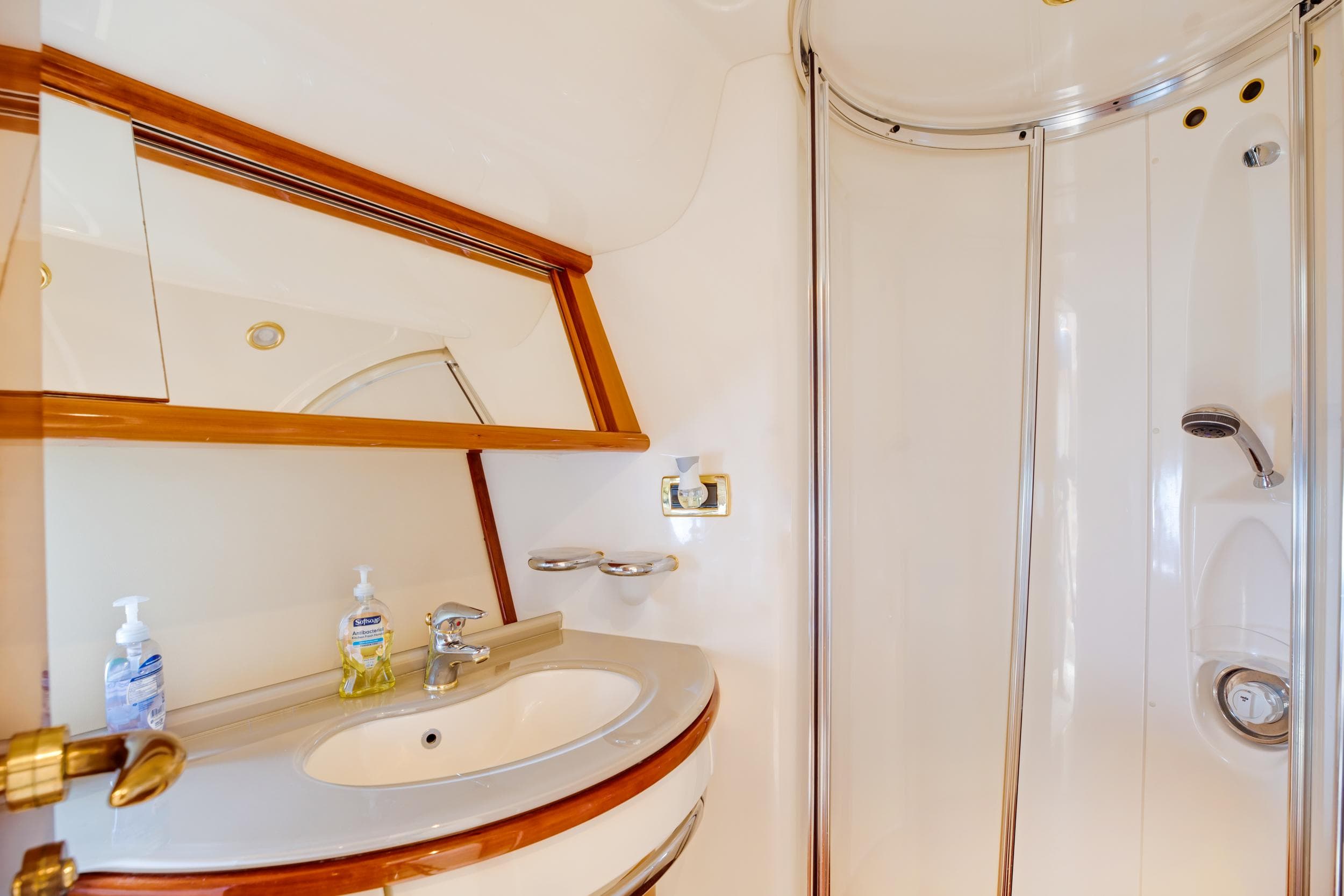 Luxurious bathroom in a 2004 Azimut 62 yacht with sink and shower.