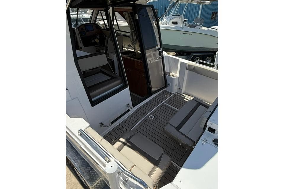 2025 Cutwater C-248 Coupe interior with seating and helm, showcasing modern design and functionality.