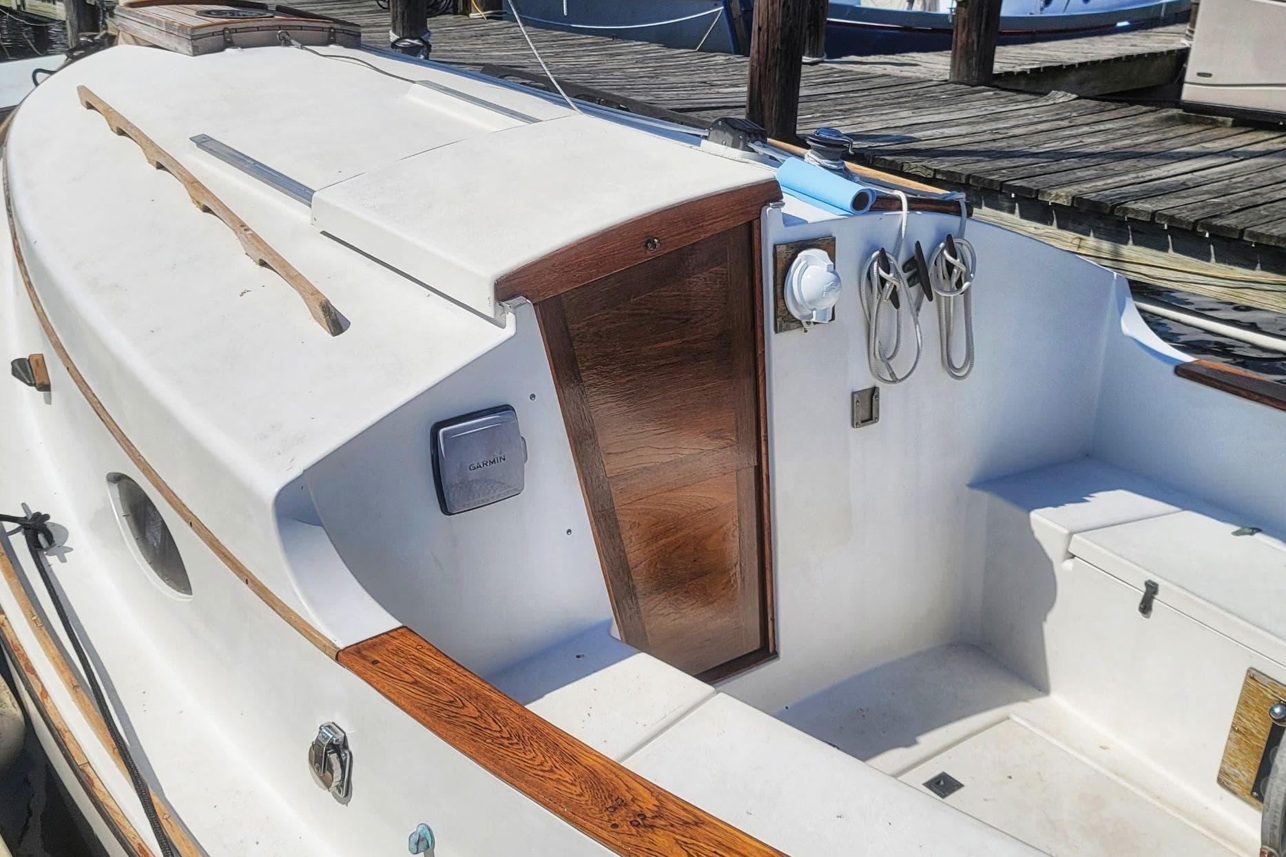 1983 Atlantic City Kitty Kat 21 boat interior with wooden accents and docked at marina.