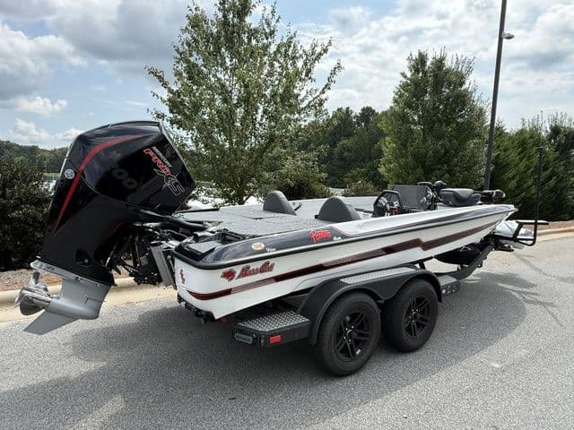 2026 Bass Cat Pantera Classic boat on trailer, parked outdoors, with trees in background.