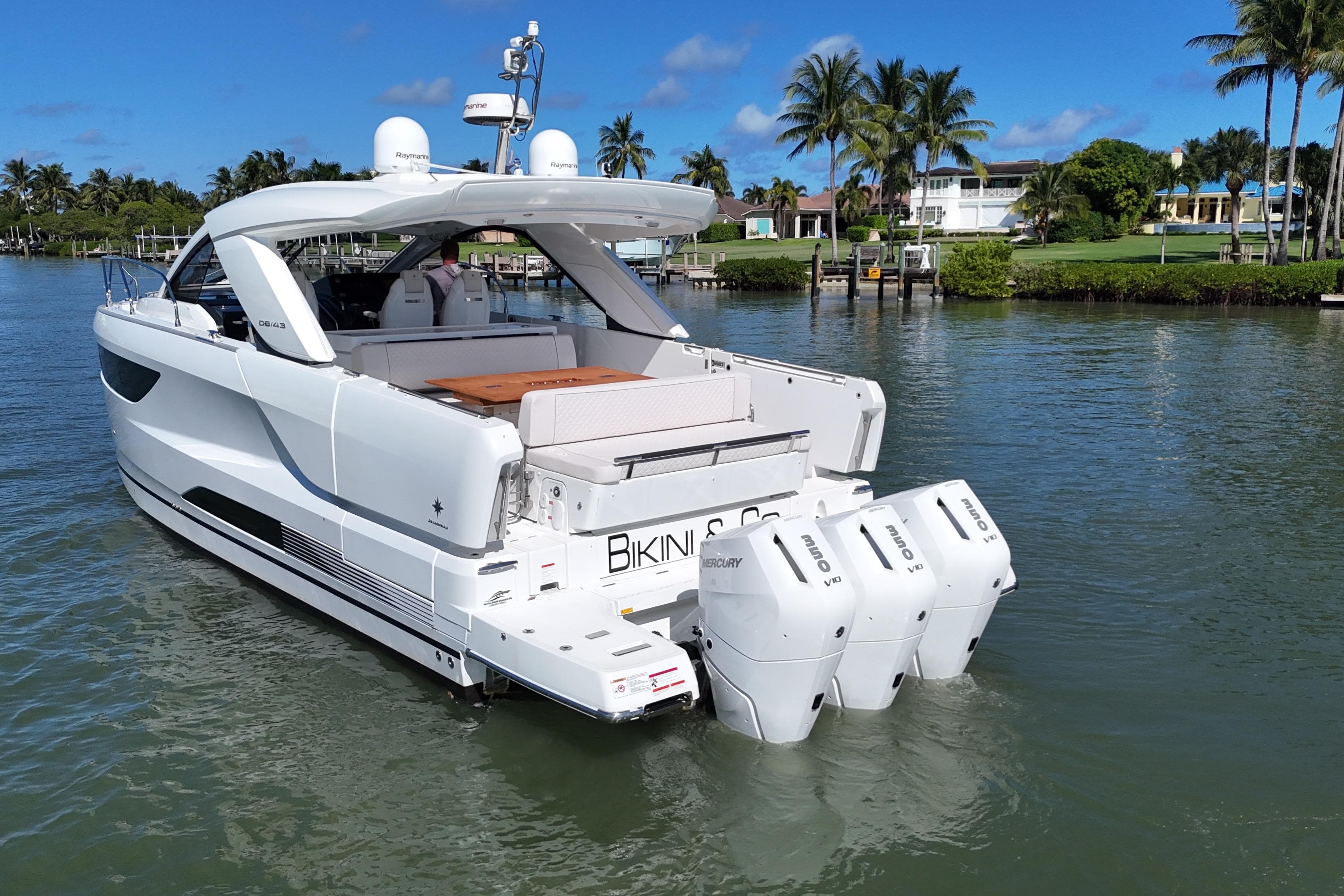 2024 Jeanneau DB43 yacht with triple Mercury outboard engines on a sunny day.