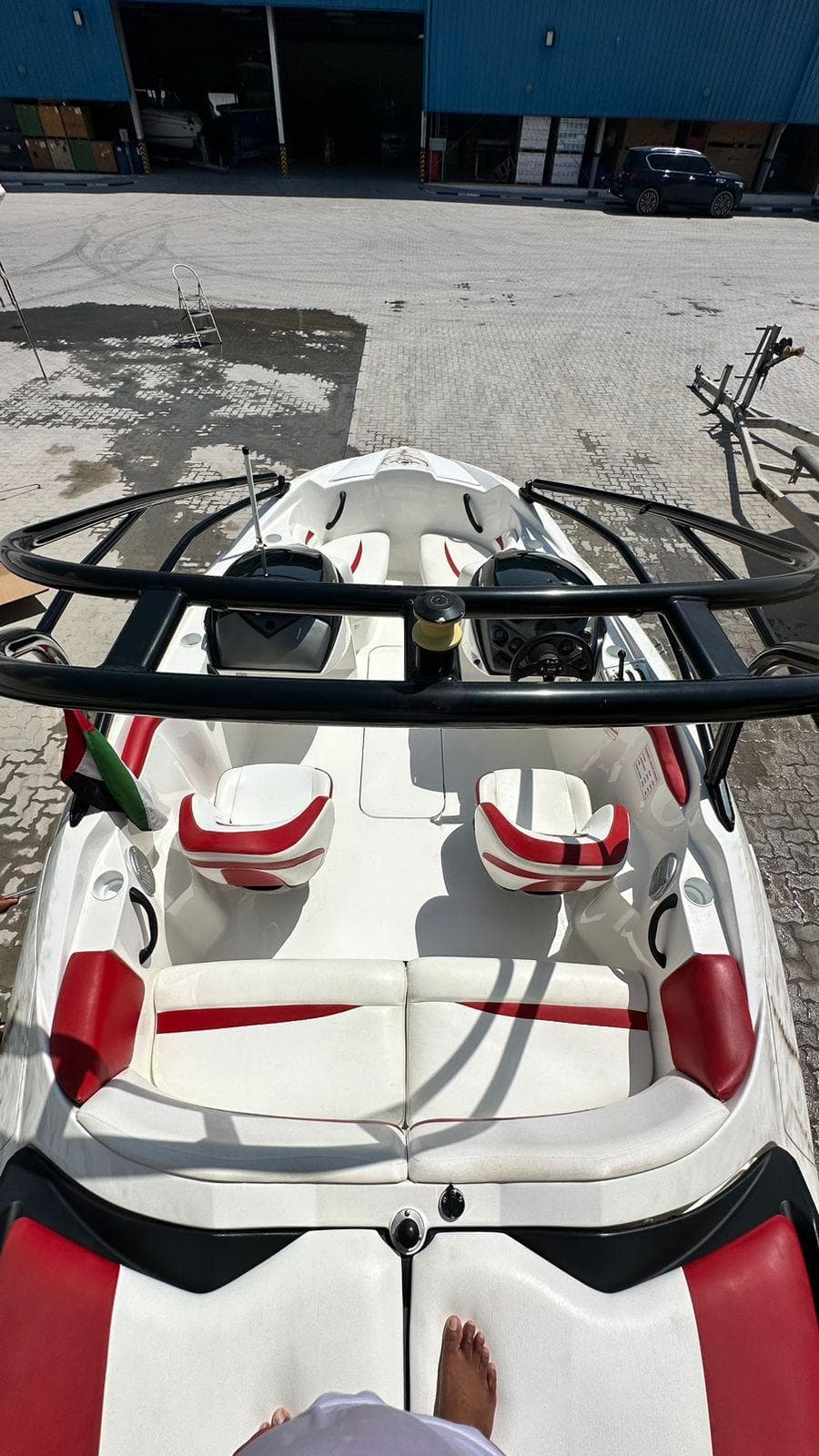 2011 Sea-Doo Sport Boats 210 Wake with red and white seating, docked outdoors.