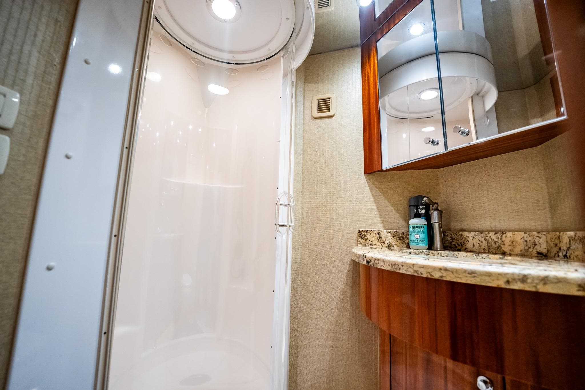 Luxurious bathroom interior of 2012 Hatteras 80 Motor Yacht with modern shower and granite countertop.