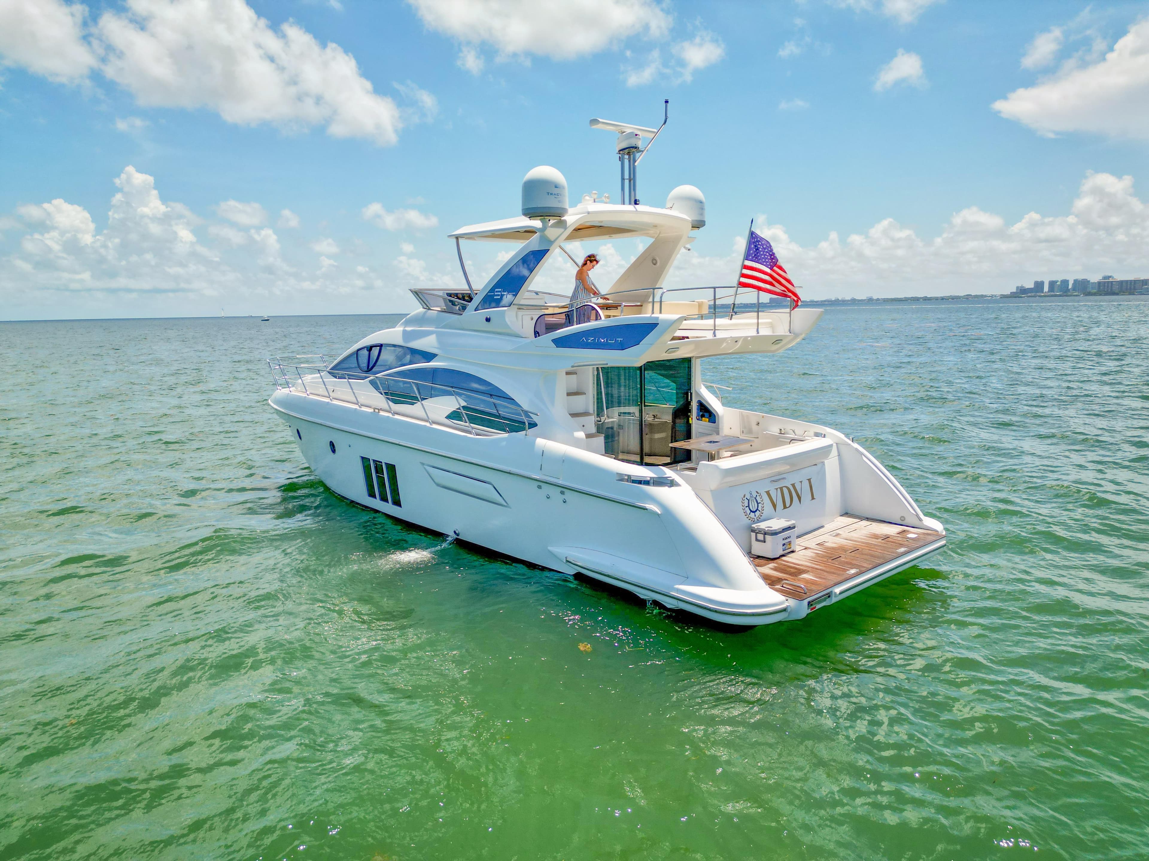Azimut 54 Fly 2015 yacht cruising on open water under a clear blue sky.