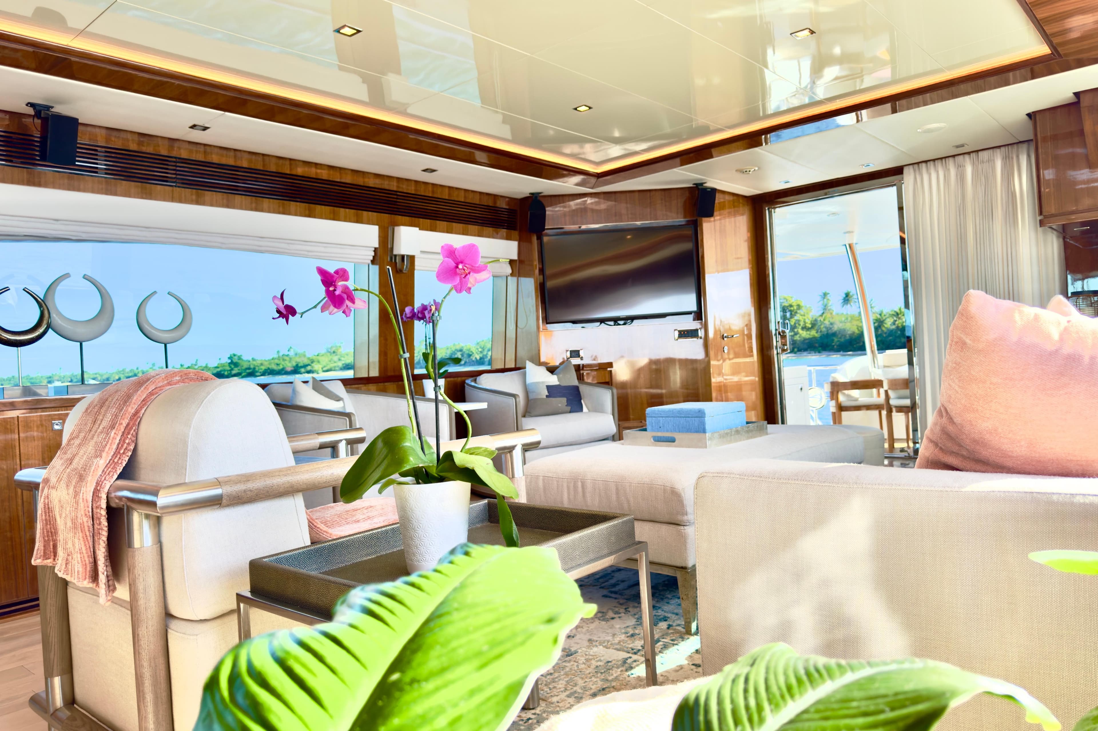 Luxurious interior of 2011 Horizon E88 yacht with elegant decor and vibrant orchids.