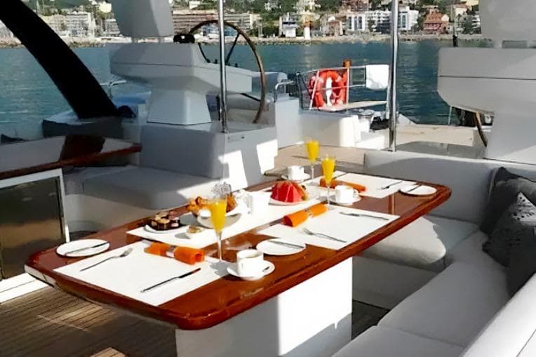 Luxurious yacht deck dining setup on 2009 Bloemsma Van Breemen 40m, with ocean view.