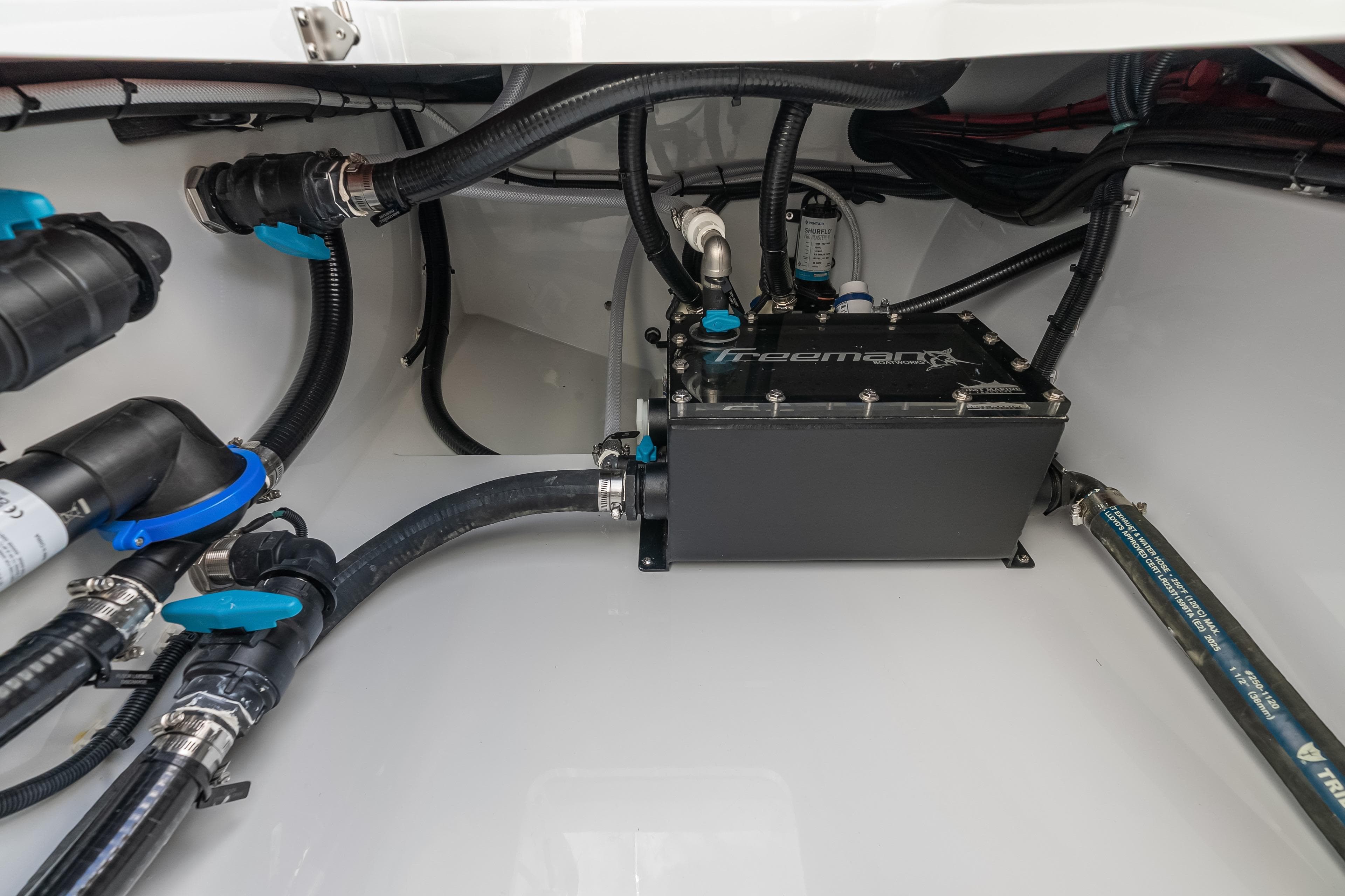 Freeman 38 boat engine compartment with hoses and components, 2026 model.