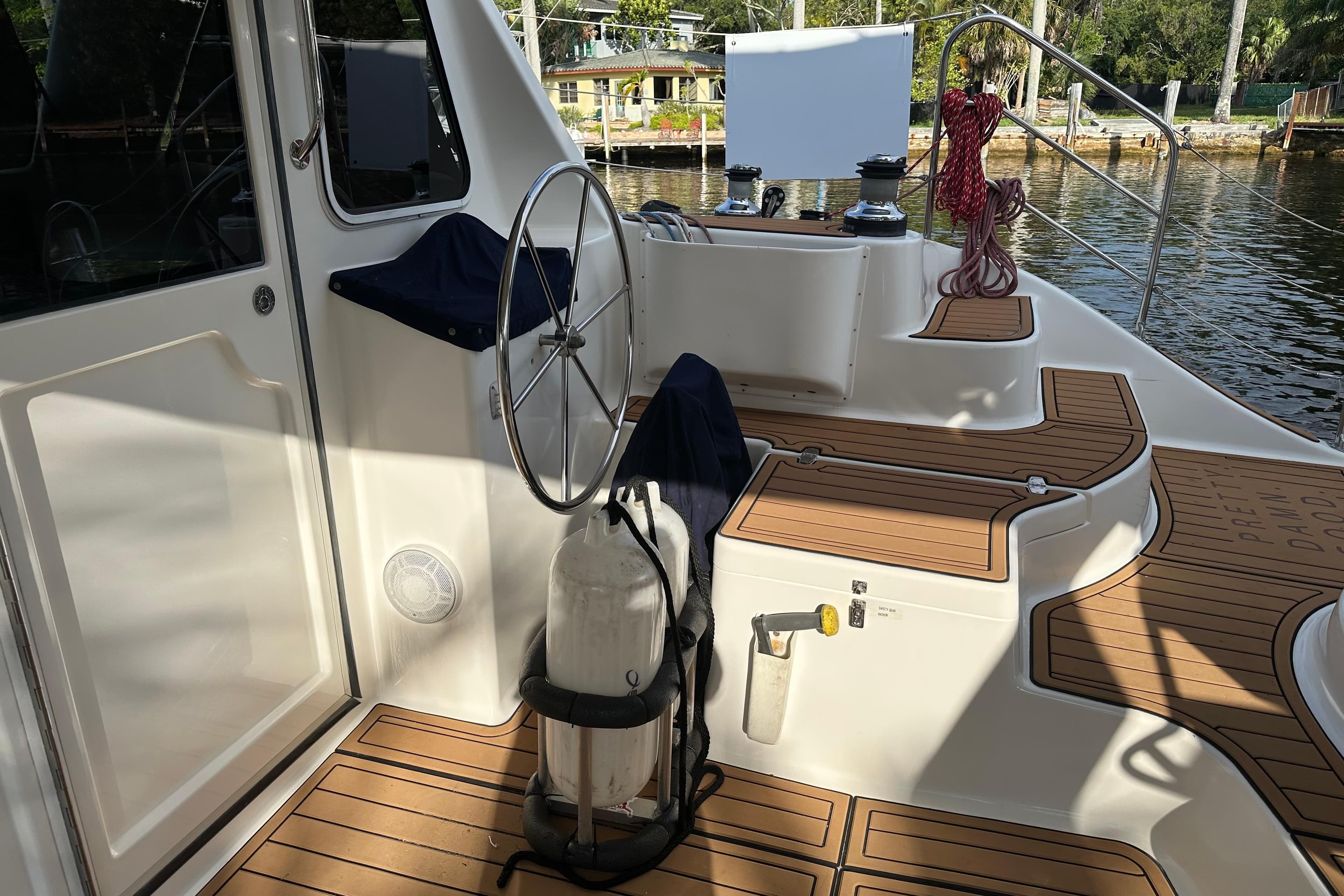 Cockpit of 2005 Seawind 1160 catamaran with wooden deck and steering wheel.