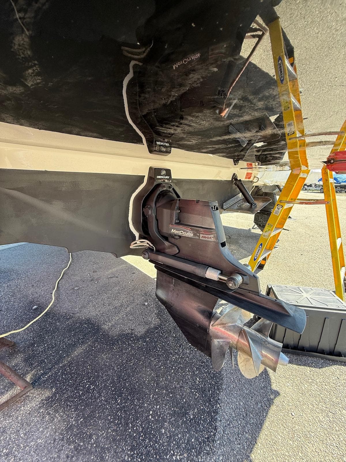 2016 Sea Ray SDX 270 boat underside with propeller and ladder visible.