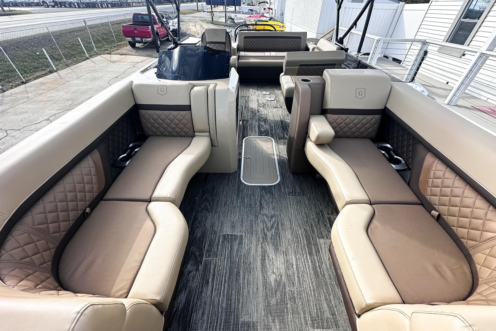 Luxurious 2025 Godfrey AquaPatio 25' Tritoon with spacious flip lounge seating.