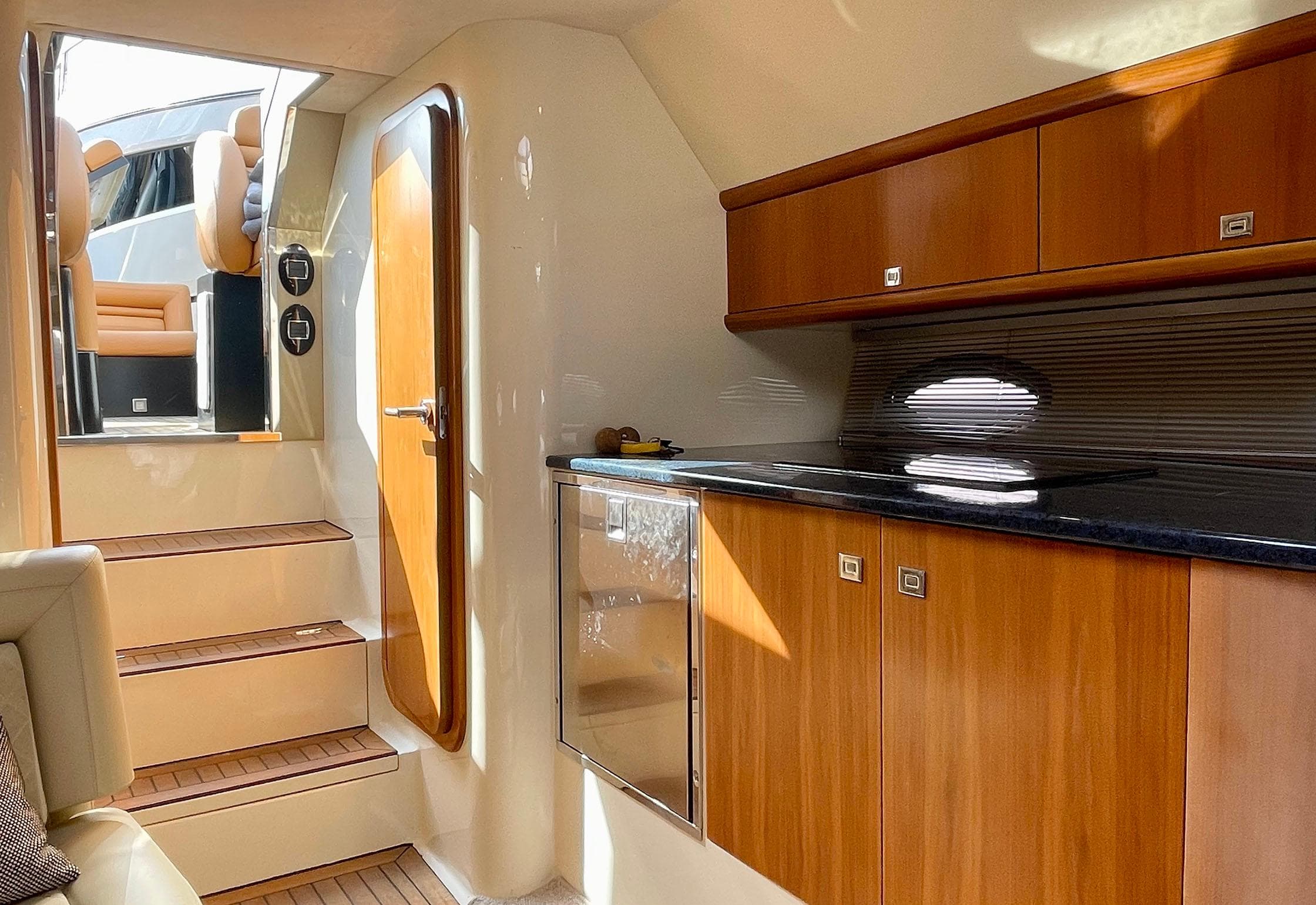 Interior of 2011 Hunton XRS 43 yacht with wooden cabinetry and stairs.