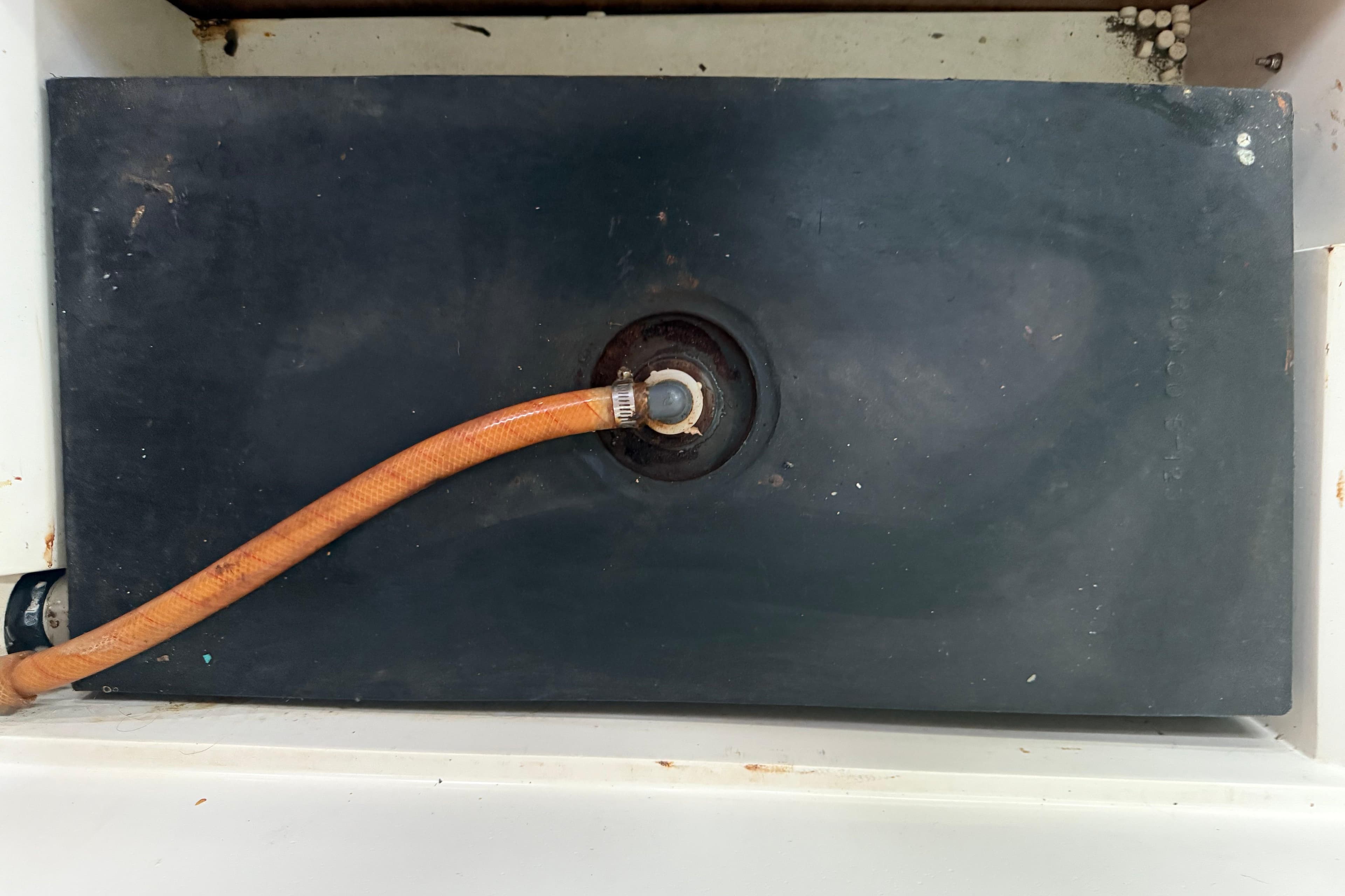Black water tank with orange hose in a 1995 Catalina 36 MkII sailboat.
