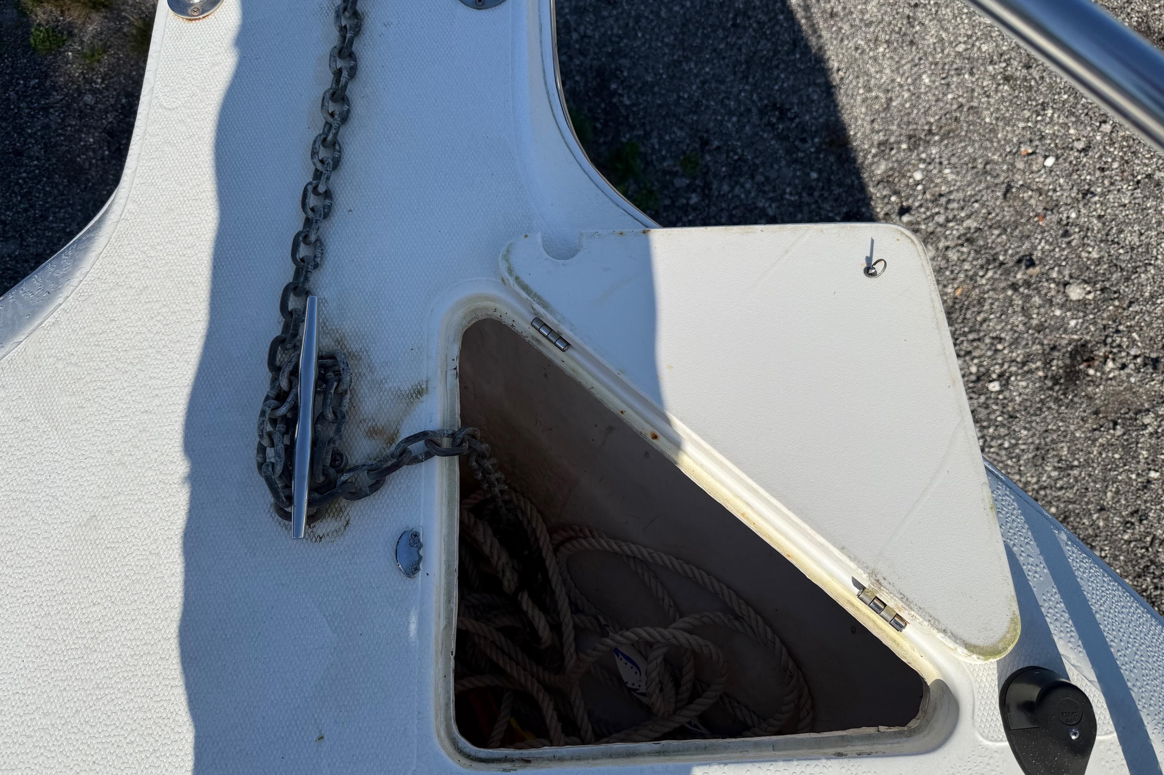 Anchor locker of a 2000 Sport-Craft 241 Walk Around boat with chain and rope.