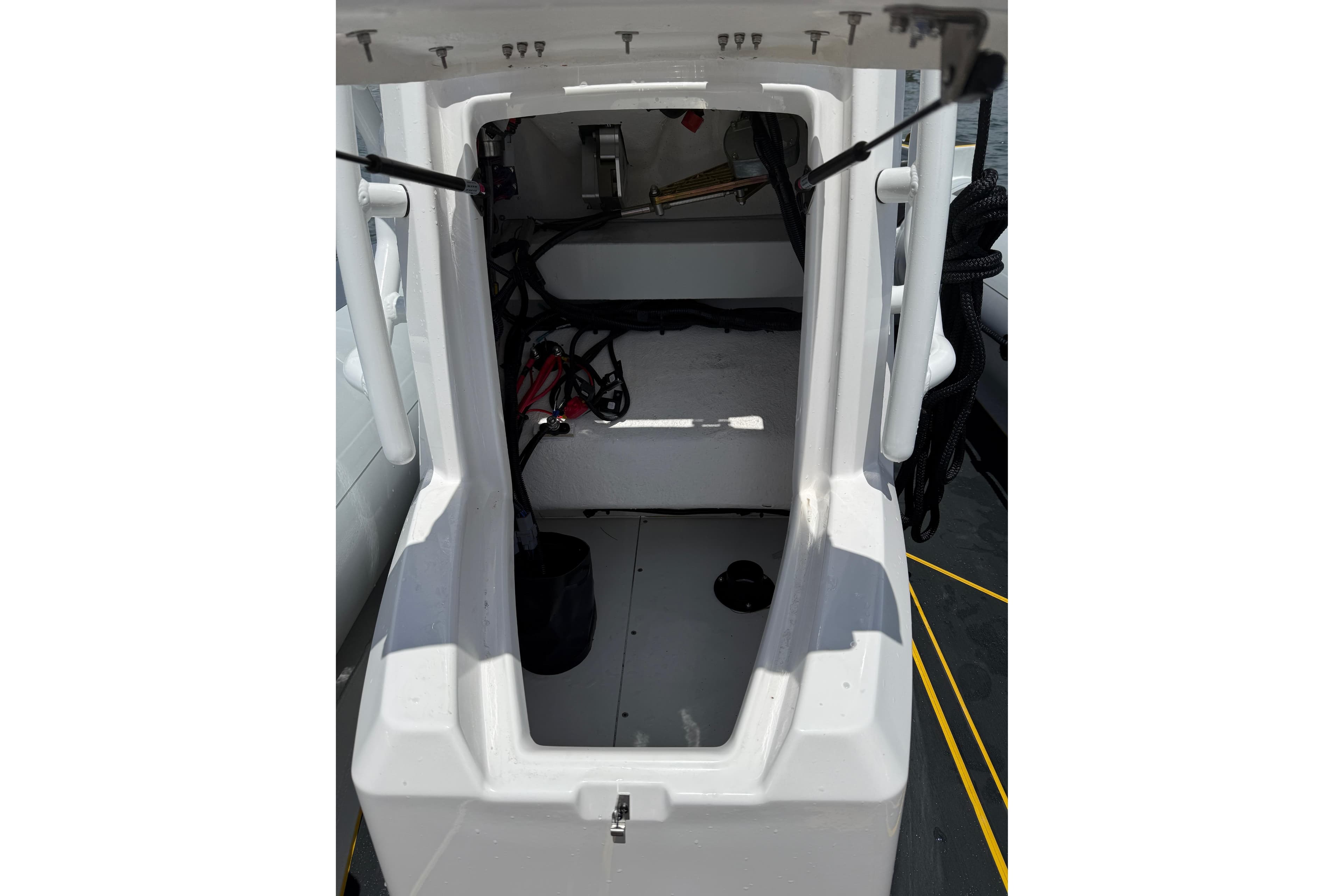 Interior view of 2026 Highfield Velox 560 boat, showcasing storage compartment and equipment.