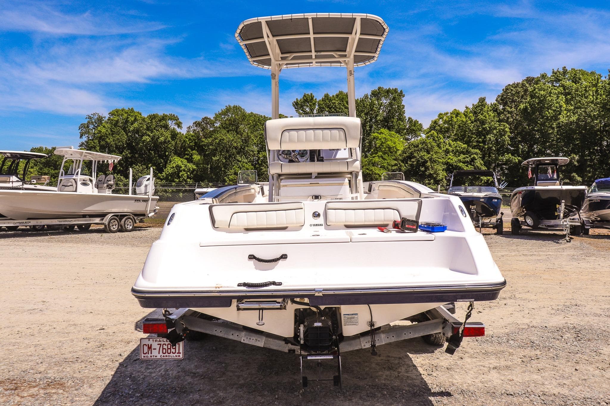 2017 Yamaha Boats 190 FSH Sport on trailer, parked outdoors under clear blue sky.