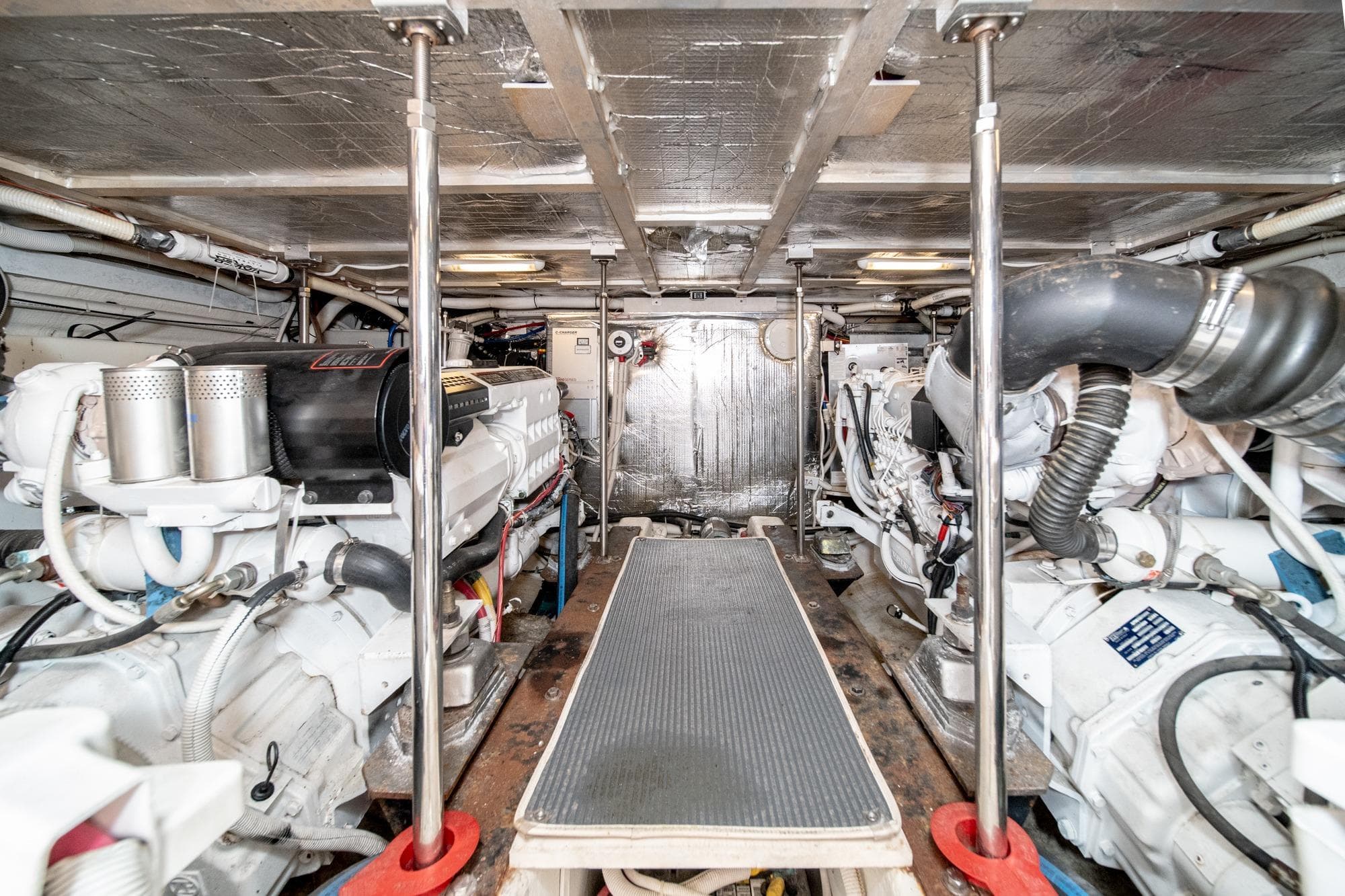 Engine room of a 2003 Carver 530 Voyager Pilothouse, showcasing dual engines and mechanical components.