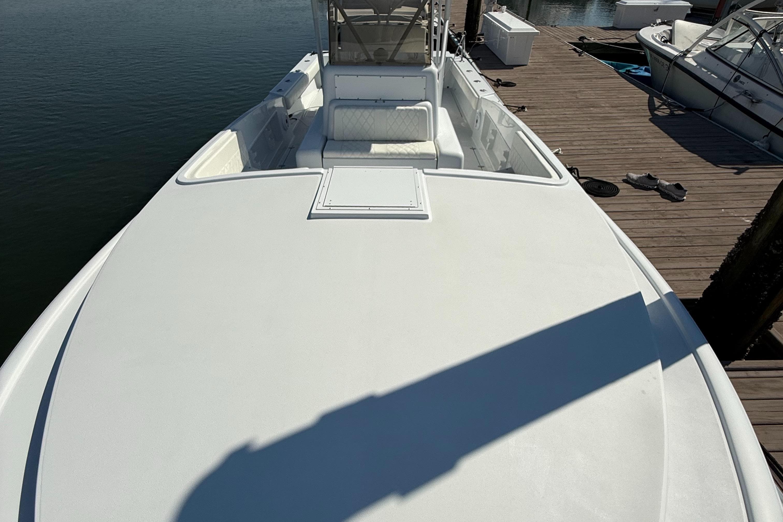 2003 Strike 35 Cuddy boat docked, showcasing spacious deck and seating area.