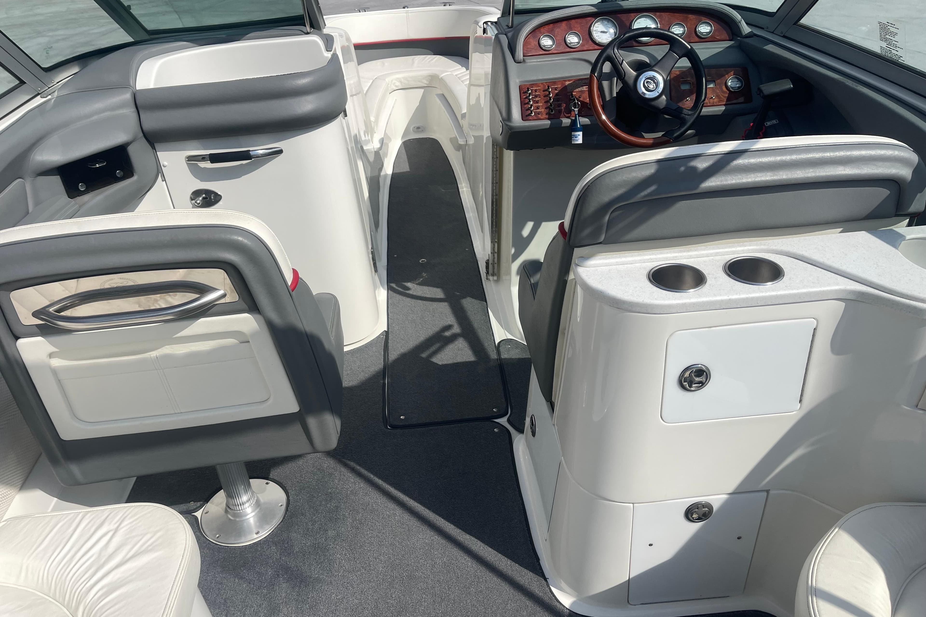 Interior of a 2004 Cobalt 282 boat featuring steering wheel and seating area.