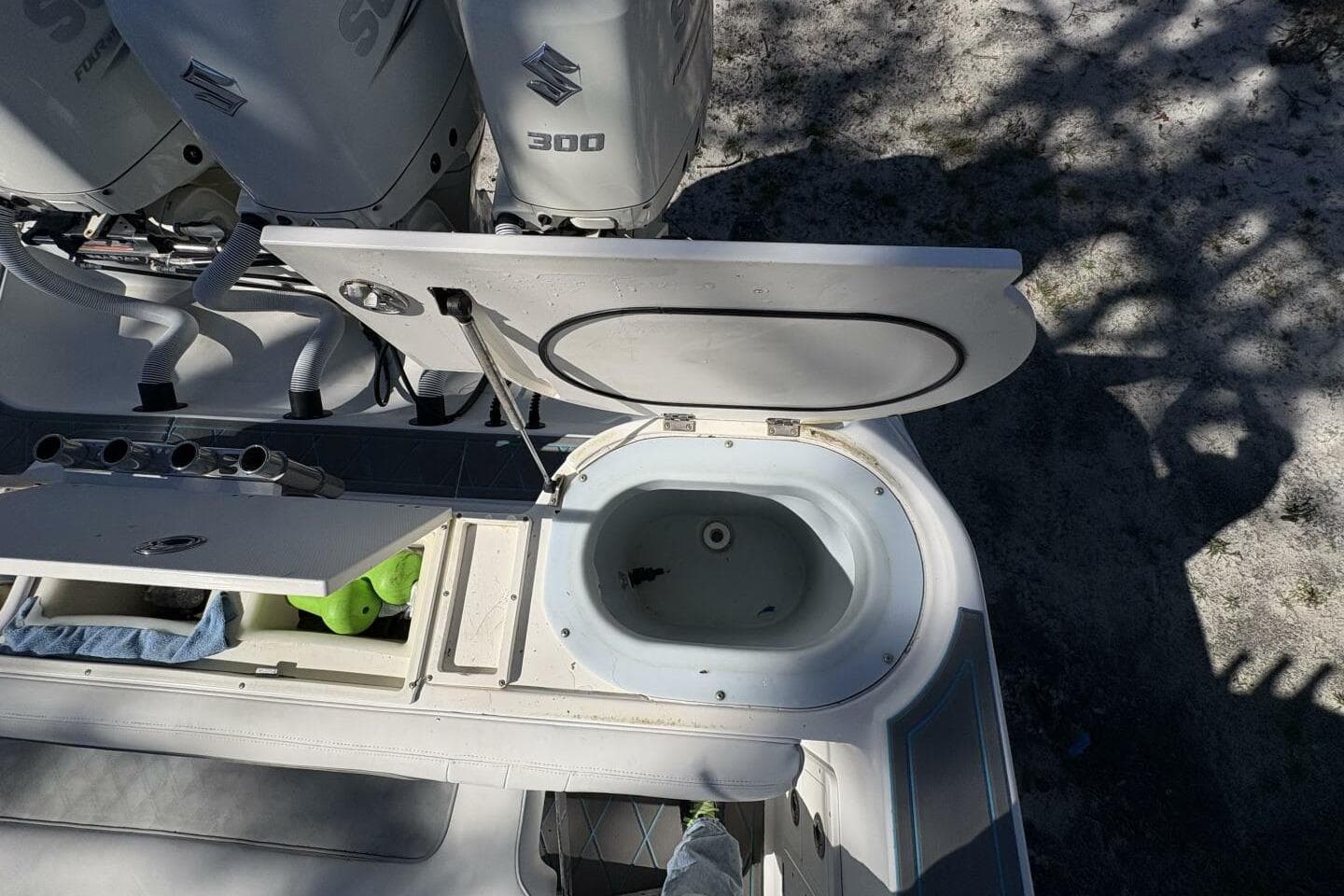 2008 Wellcraft 35 Scarab Sport boat with open storage compartment and Suzuki 300 engines.
