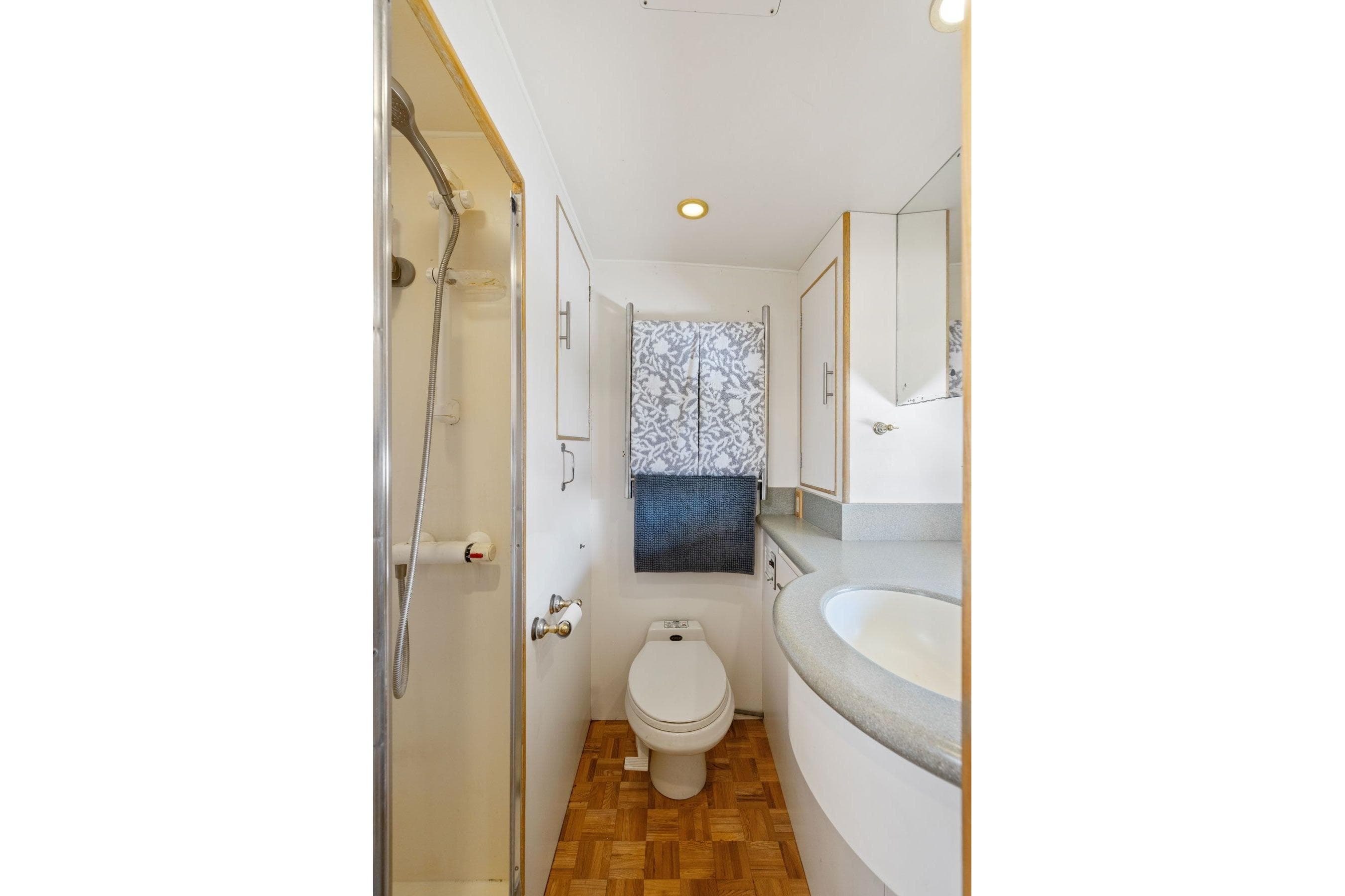 Bathroom interior of 1991 Ocean Alexander 520 Pilothouse yacht, featuring shower and toilet.