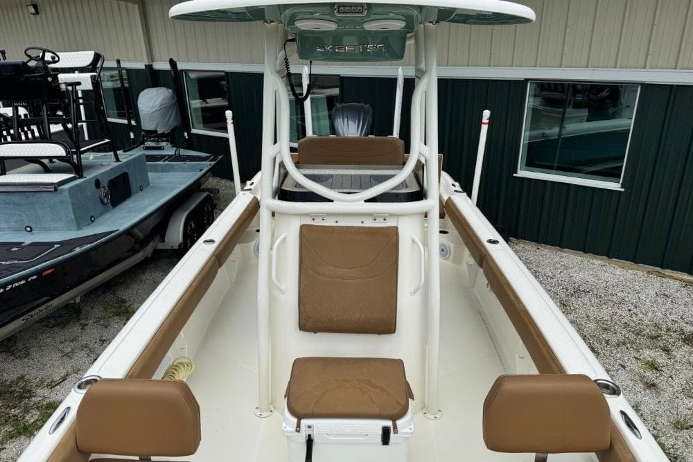 2021 Skeeter SX2550 Family boat with brown seating, parked outdoors.