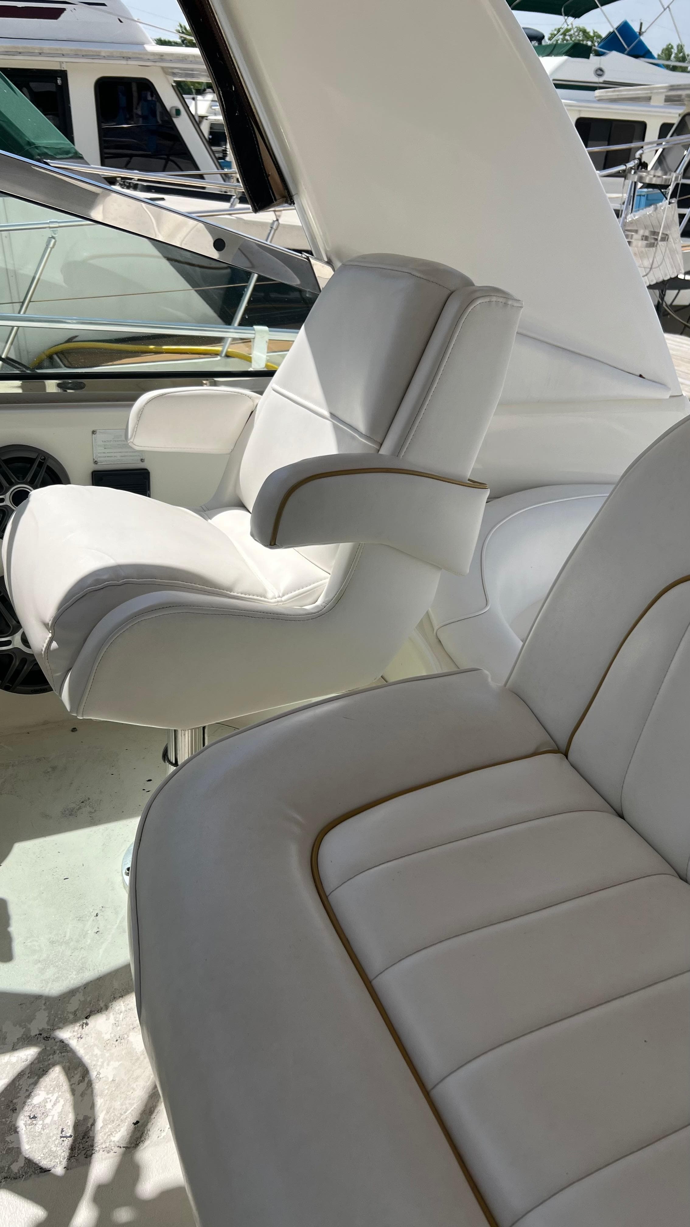 Interior seating of a 1997 Sea Ray 400 boat with white leather upholstery.