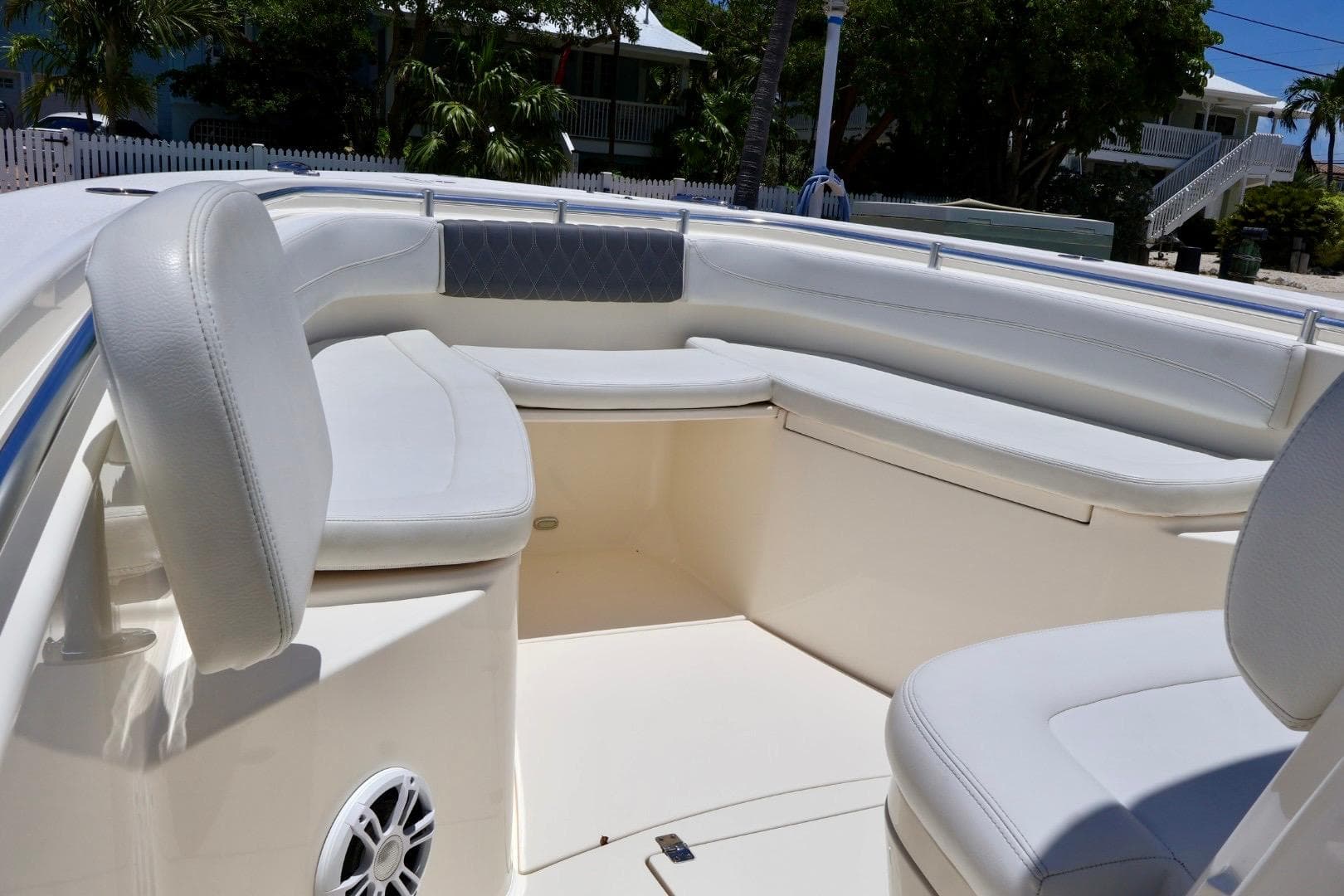 2022 Cobia 301 Center Console boat interior with cushioned seating and speaker.