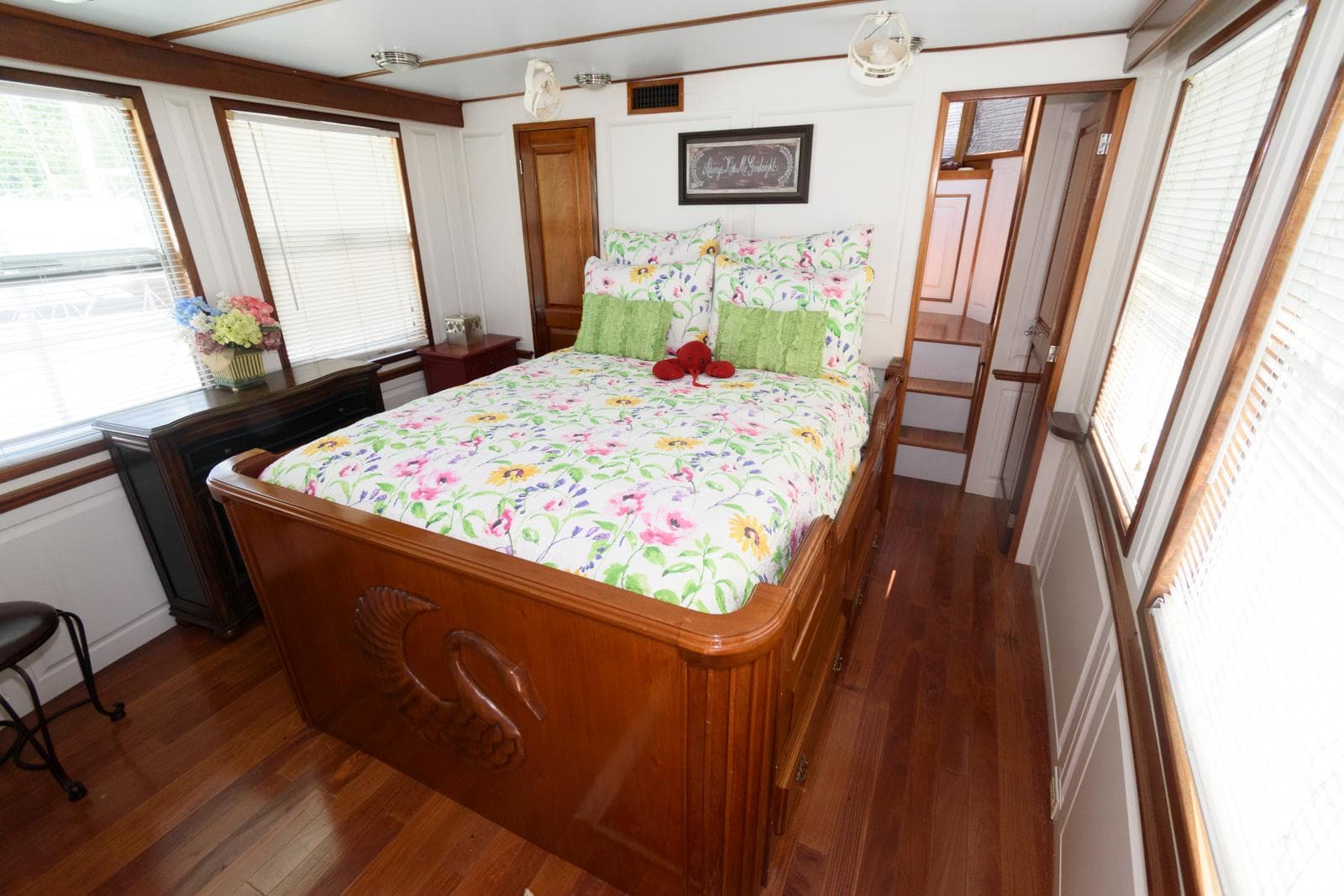 Cozy bedroom with floral bedding in a 1997 Florida Bay Coasters 35 houseboat.