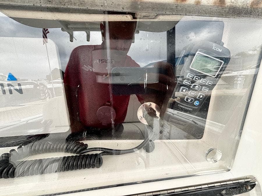 2003 Marlago FS35 boat dashboard with radio and coiled cables.