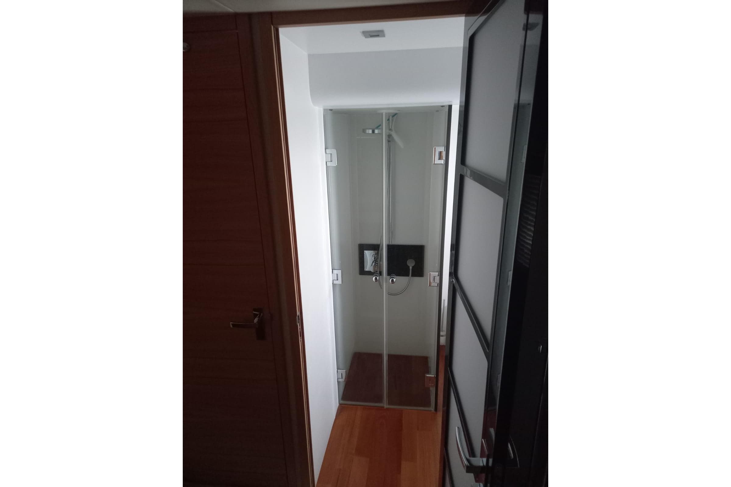 Shower area inside 2012 Fairline Squadron 65 yacht, featuring glass doors and modern fixtures.