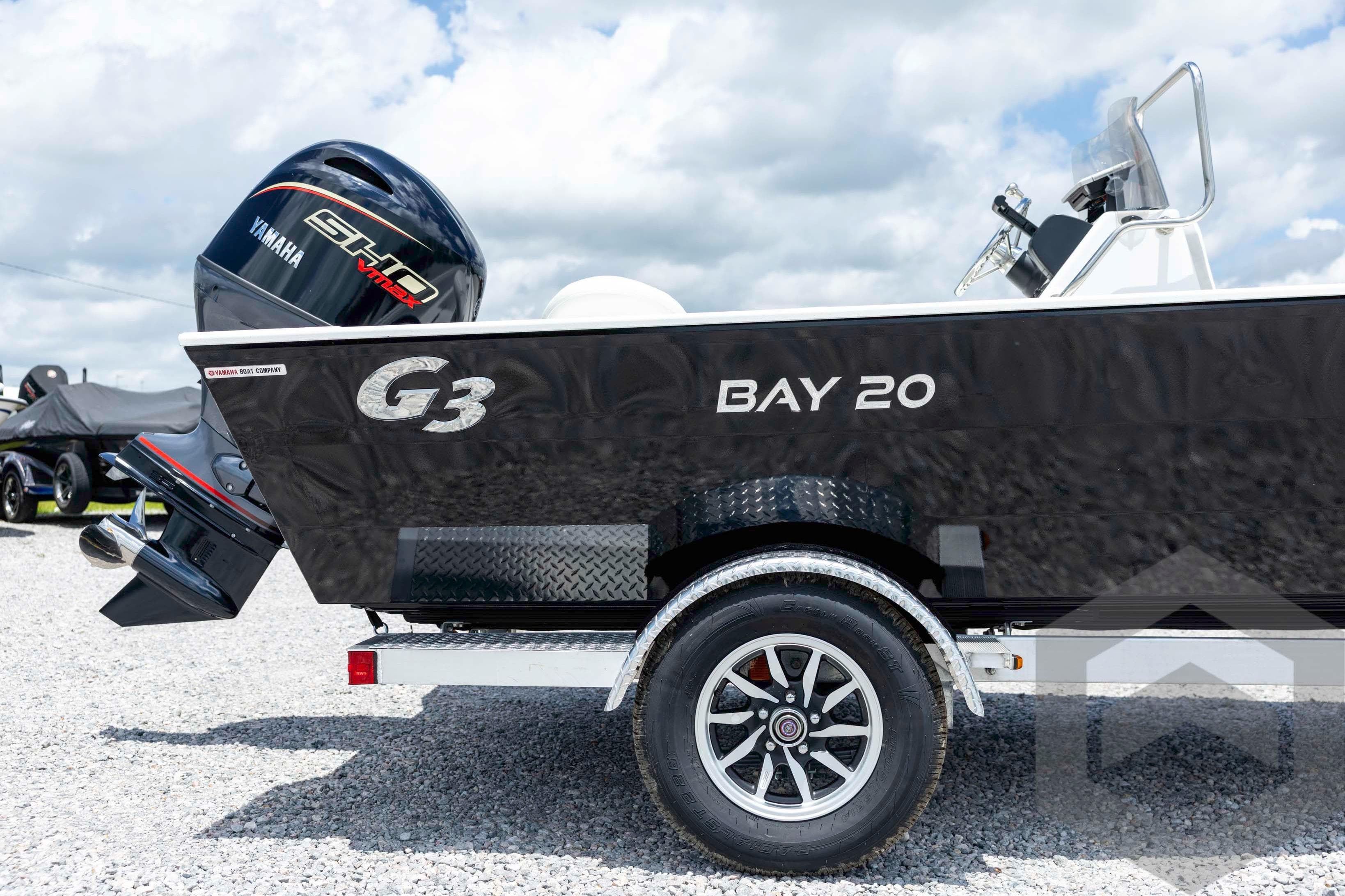2026 G3 Bay 20 boat with Yamaha engine on a trailer, parked on gravel.