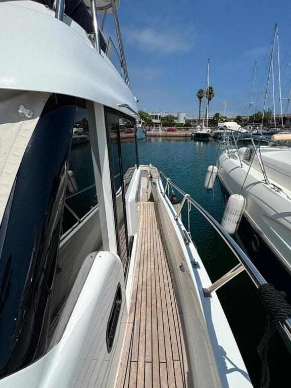 Rodman 1290 Evolution yacht docked in marina, 2022 model, sunny day.