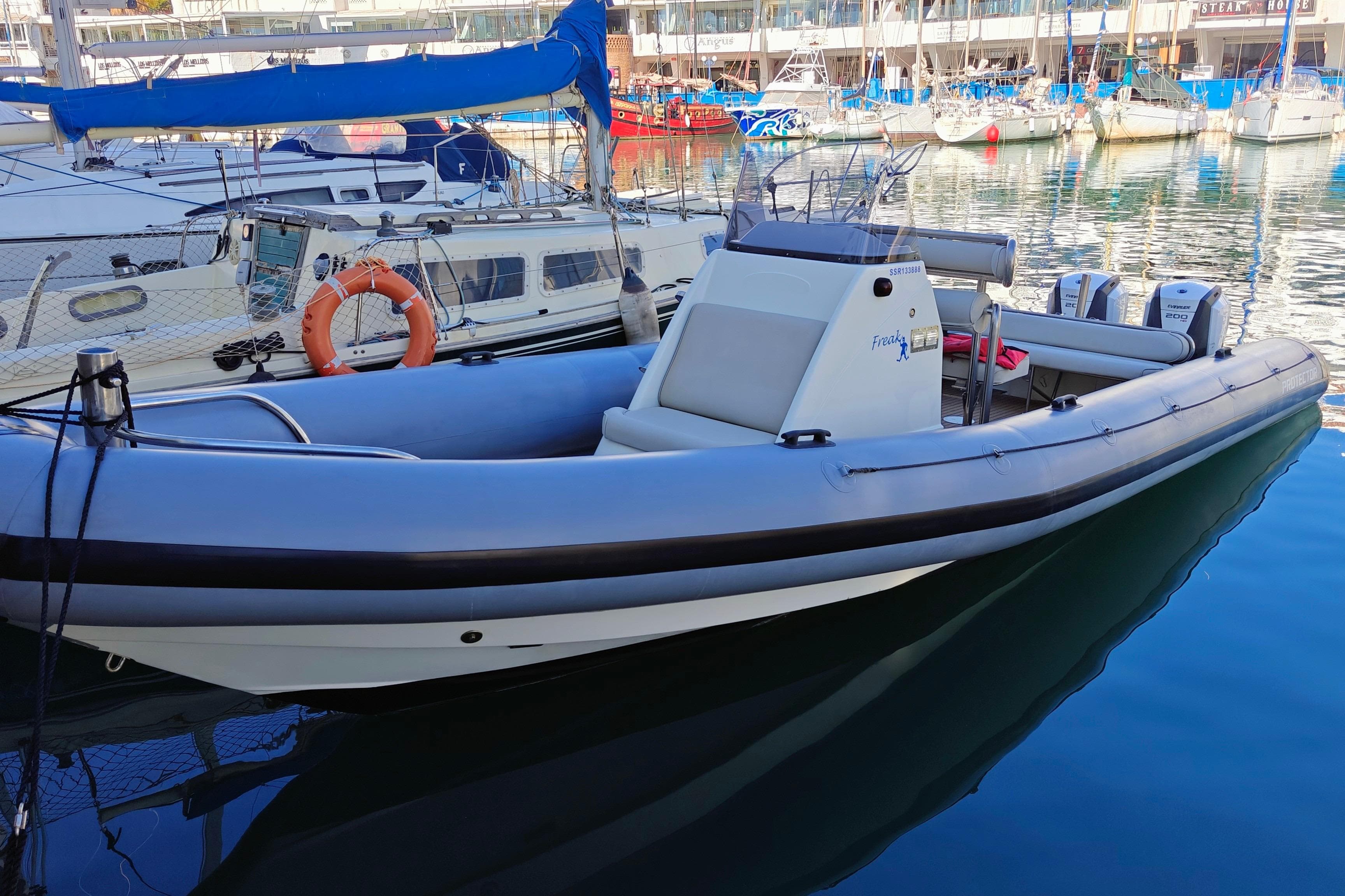 2005 Protector RIB 8.75m boat docked in a marina, featuring dual engines.