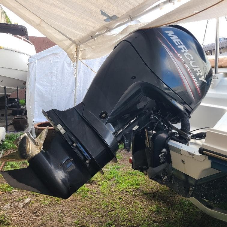 2019 Bayliner VR5 Bowrider OB with Mercury outboard motor under a canopy.