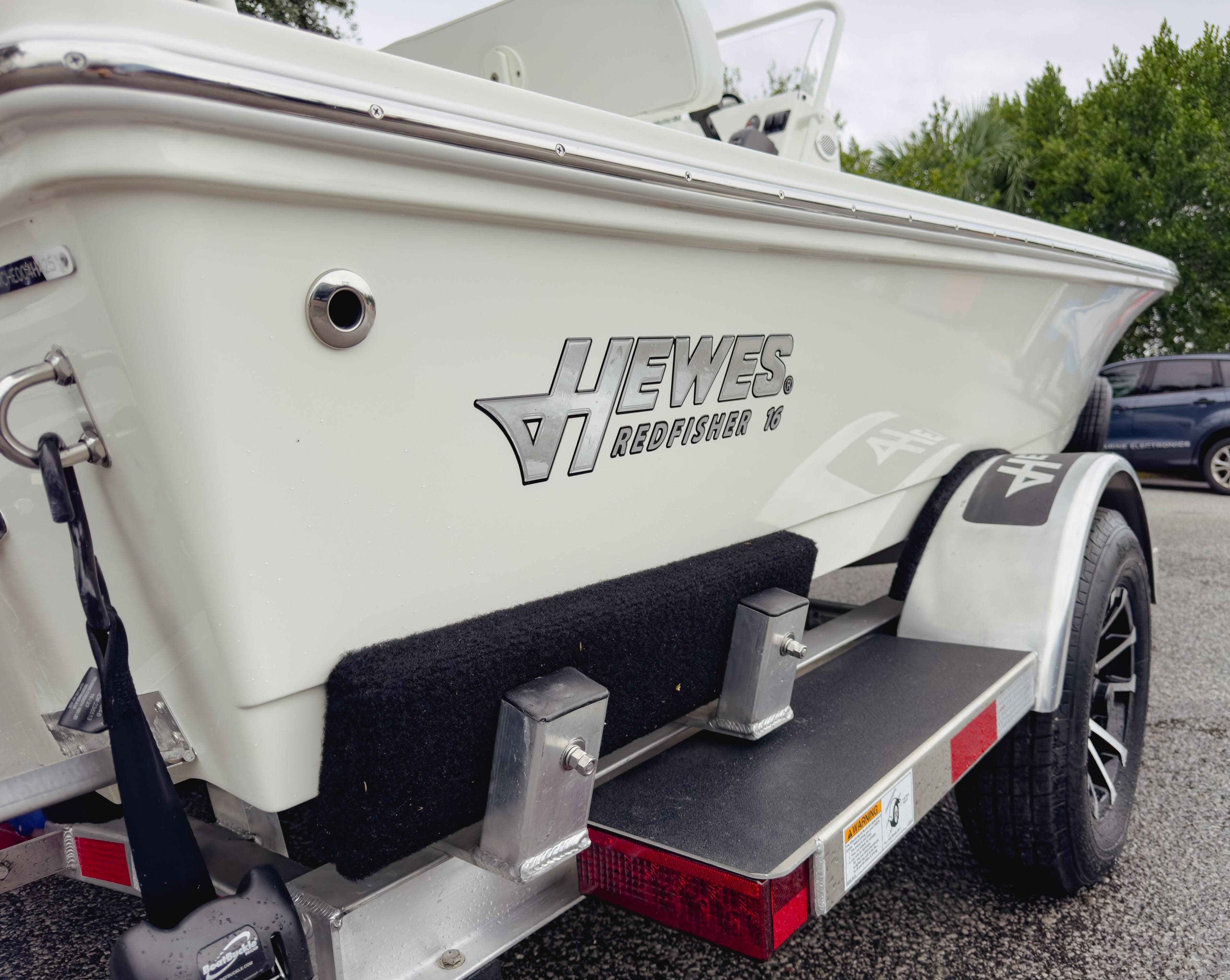 2025 Hewes 16 Redfisher boat on trailer, side view.