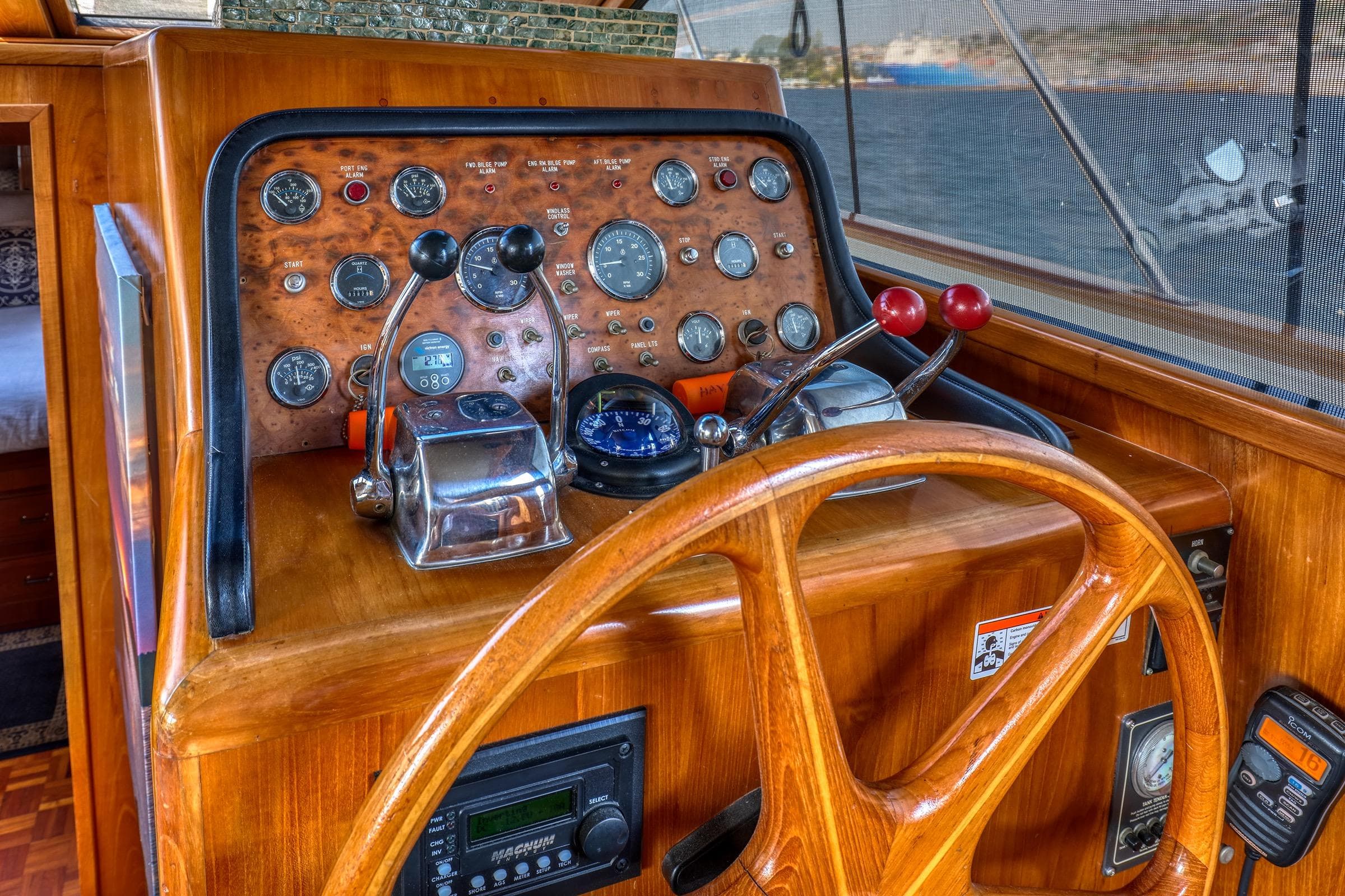 1987 Ocean Alexander Motoryacht helm with wooden wheel and classic instrument panel.