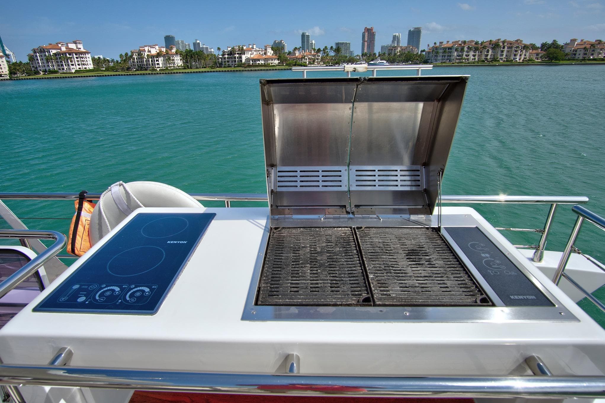 Outdoor grill and cooktop on 2017 Azimut 72 Flybridge yacht, with scenic waterfront view.