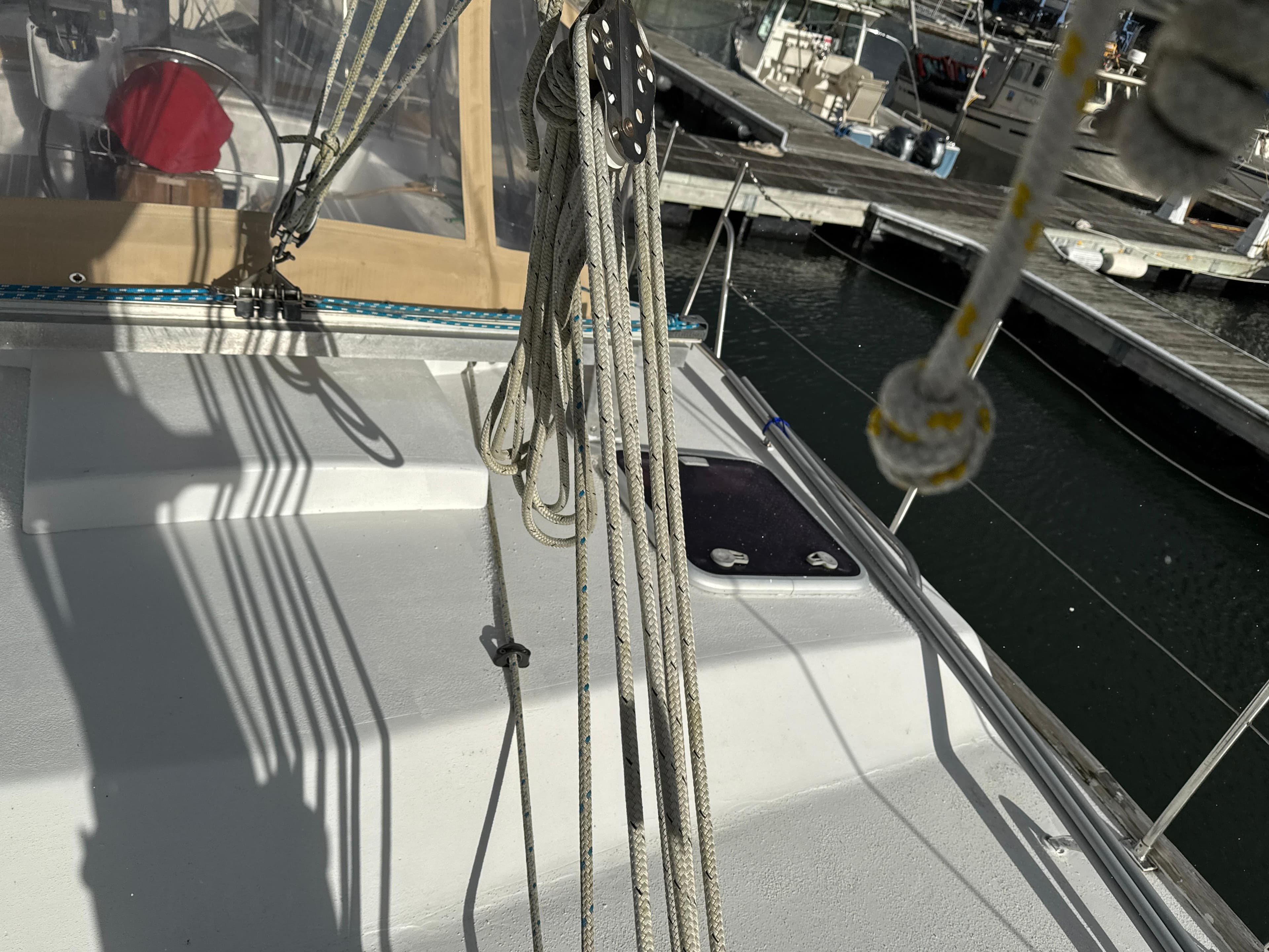 Sailboat deck of 1980 Bruce Roberts Mauritius 43 at marina, showing rigging and dock.