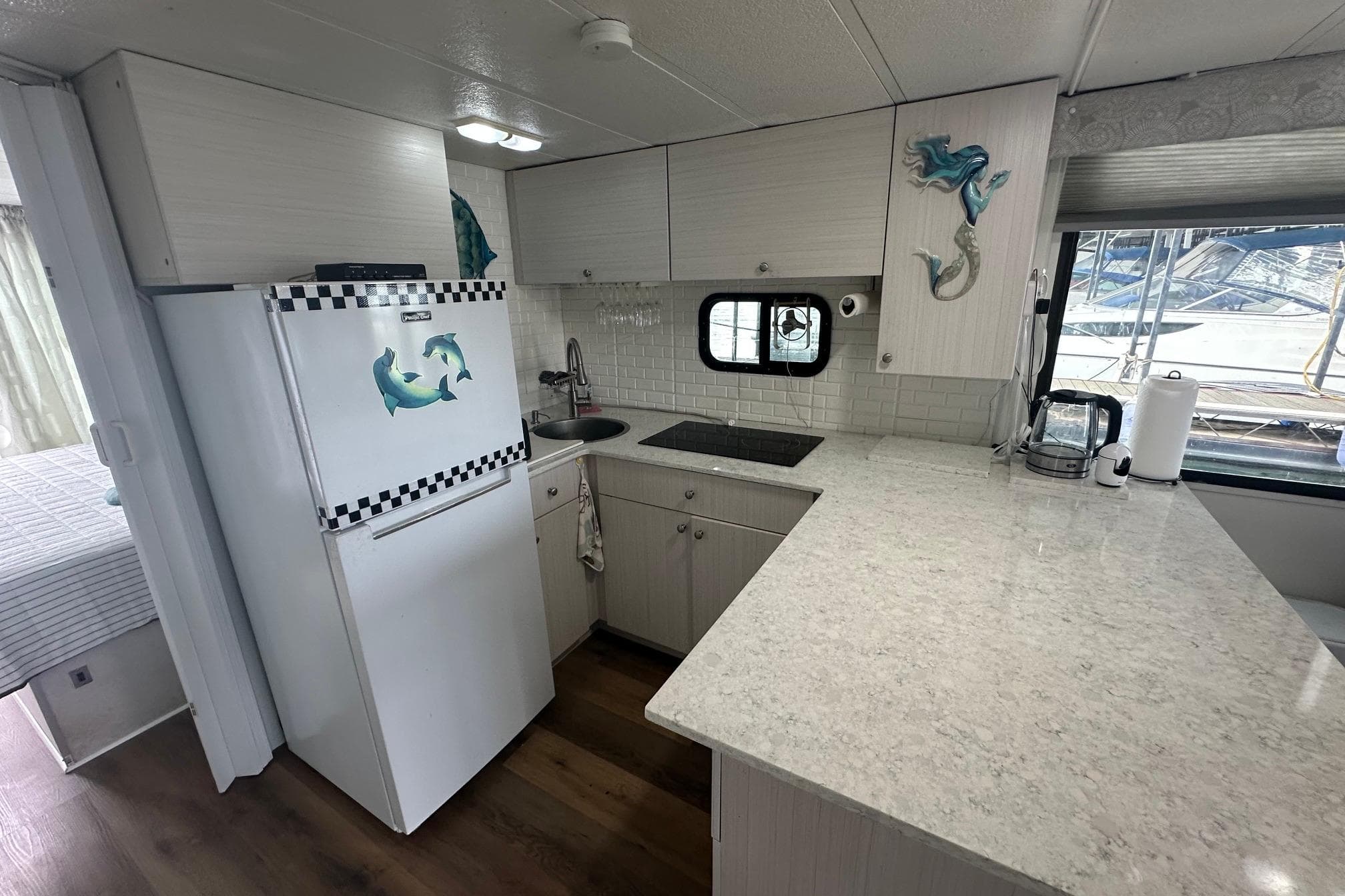 Interior of a 1996 Catamaran Cruisers 12x42 with modern kitchen and nautical decor.