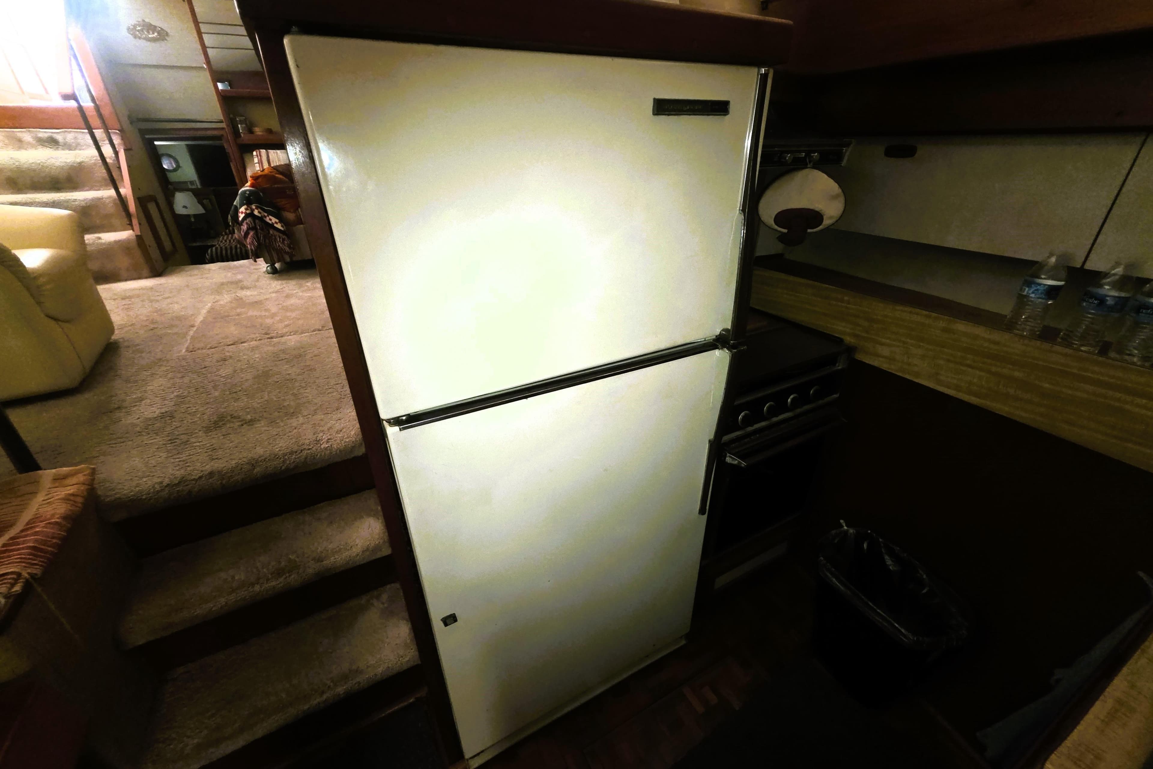 1979 Trojan 44 Motor Yacht interior with refrigerator and kitchen area.